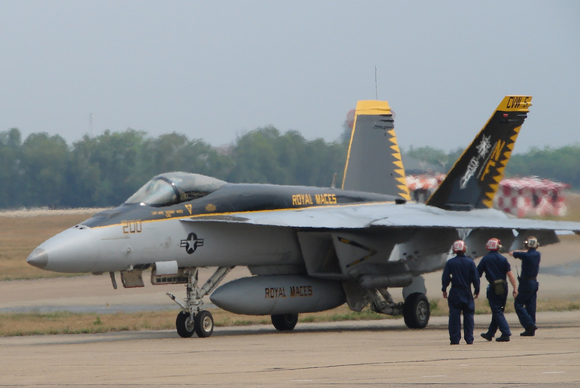 Sailors from Carrier Air Wing 5, Naval Air Facility-Atsugi, Japan, receive an F/A-18E Super Hornet at Korat Royal Thai Air Force Base, Thailand, after a sortie March 10.  The Sailors are deployed to Thailand in support of Cope Tiger 2009, an annual, multilateral large force aerial exercise conducted in Thailand including U.S., Thai and Singaporean military forces. The two-week exercise includes both flying and humanitarian missions conducted in Korat and Udon Thani, Thailand. Cope Tiger 2009 kicked off March 9 and will conclude March 20. (U.S. Air Force Photo/Capt. Erika Yepsen)                