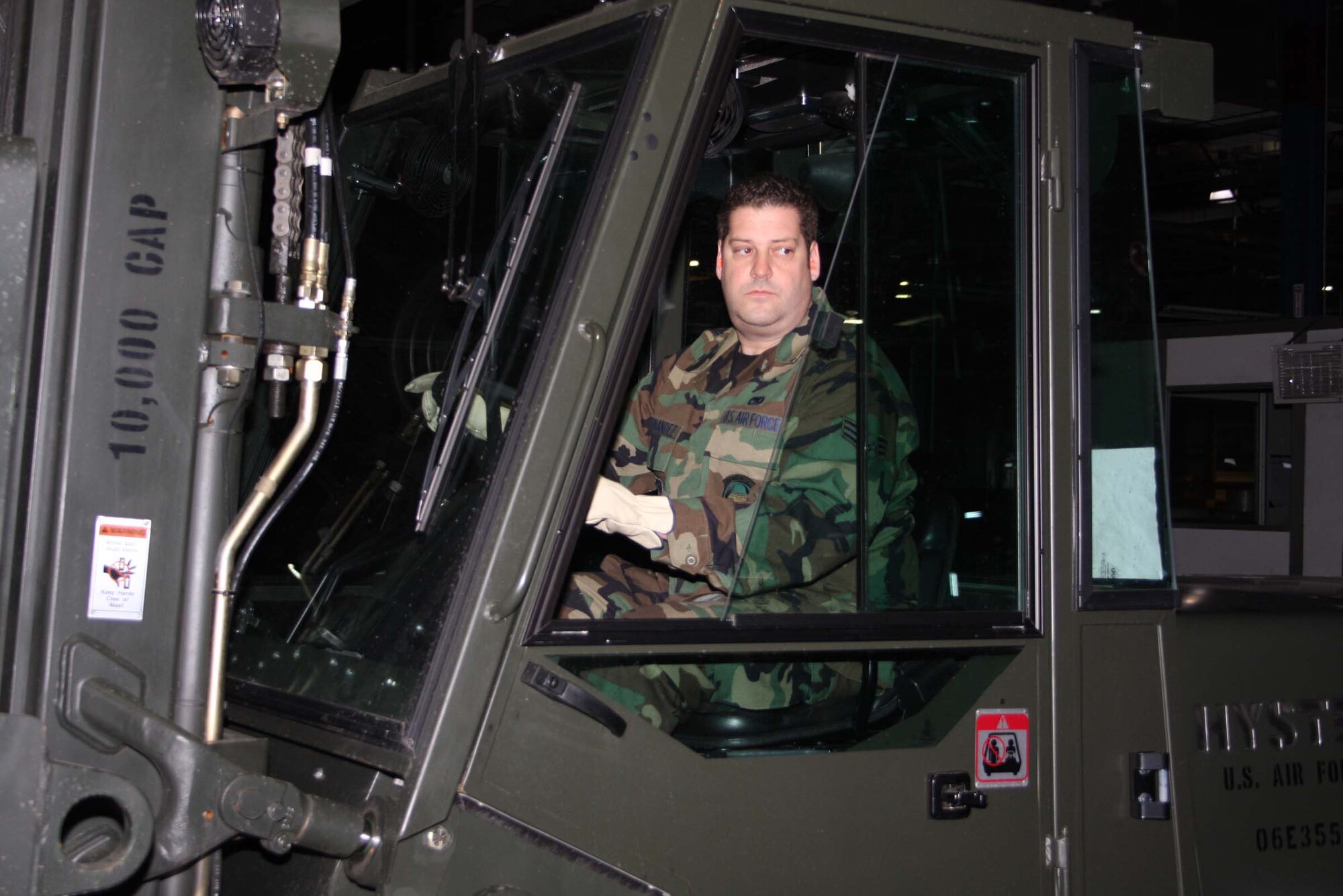 WRIGHT-PATTERSON AFB, Ohio – Senior Airman Russ Hernandez, 87th Aerial Port Squadron, maneuvers a fork lift to move a pallet across the flight line as part of a pallet building training scenario. The squadron spent the weekend building and moving pallets to prepare for future deployments. (Air Force photo/Senior Airman Ken LaRock) 