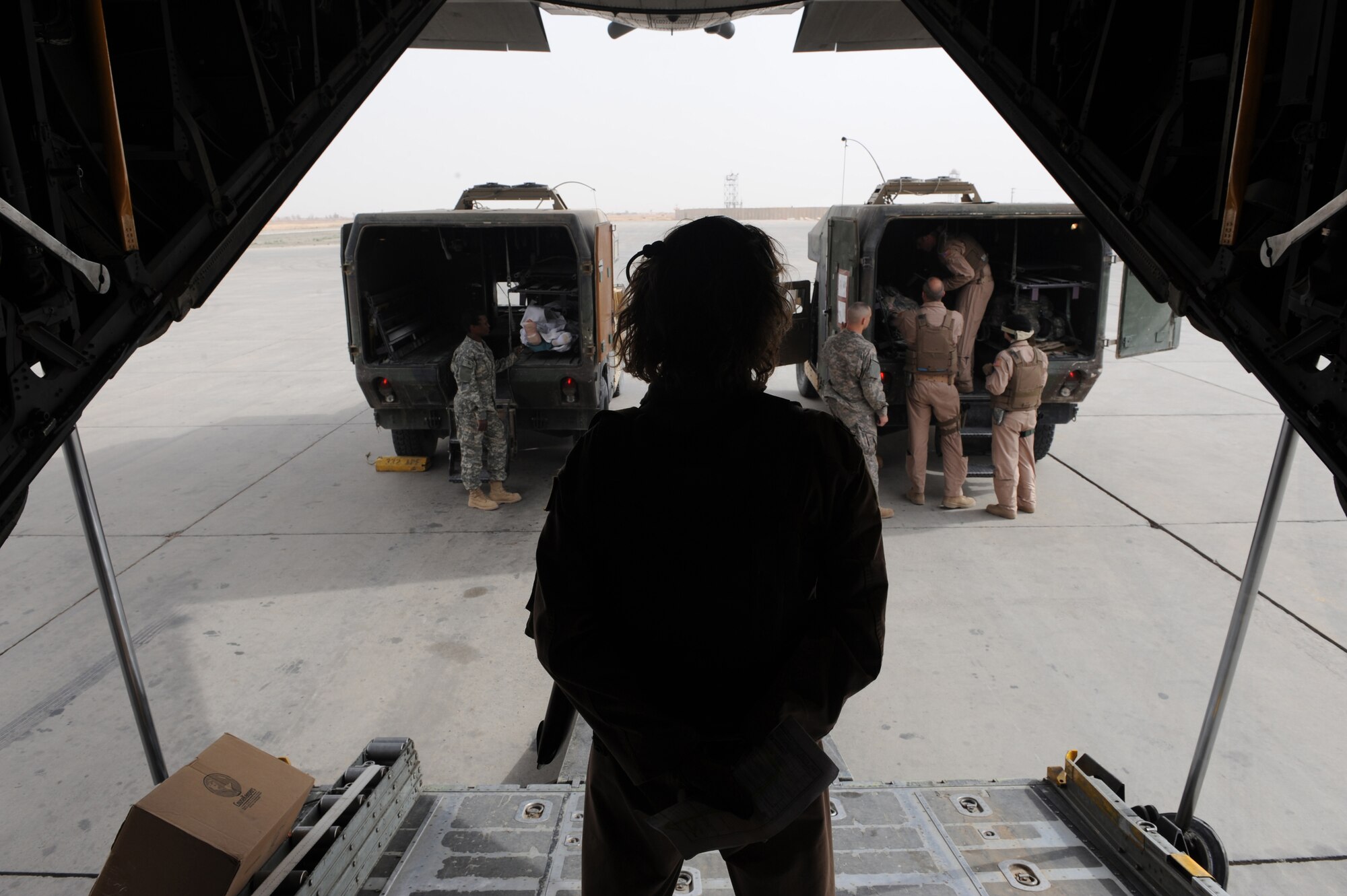 CAMP SPEICHER, Iraq ? Capt. Karen Knoblock, 332nd Expeditionary Operations Support Squadron Expeditionary Aeromedical Evacuation Flight nurse, oversees the process of off-loading patients from an HMMWV ambulance varient Feb. 27.  Airmen in the 332nd EAEF transport servicemembers wounded, injured or sick from remote locations to a higher level of medical care. Knoblock is deployed from Dobbins Air Reserve Base, Ga., and is a native of Bay City, Mich. (U.S. Air Force photo/Senior Airman Elizabeth Rissmiller)