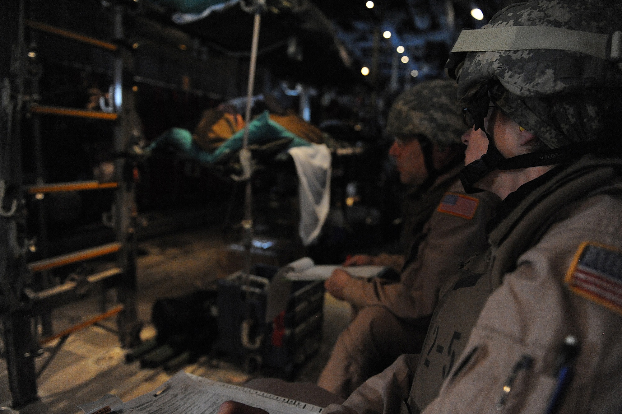 JOINT BASE BALAD, Iraq ? Staff Sgt. Edna Buckelew, 332nd Expeditionary Operations Support Squadron Expeditionary Aeromedical Evacuation Flight medical technician, and Maj. David Rodberg, 332nd EOSS EAEF nurse, review patient records while keeping an eye on their passangers Feb. 27. The 332nd EAEF transports servicemembers wounded, injured or sick from remote locations to a higher level of medical care. Buckelew is deployed here from Scott Air Force Base, Ill., and is a native of Avon, Ind. Rodberg is deployed from Dobbins Air Reserve Base, Ga., and is from Atlanta. (U.S. Airforce photo/Senior Airman Elizabeth Rissmiller)