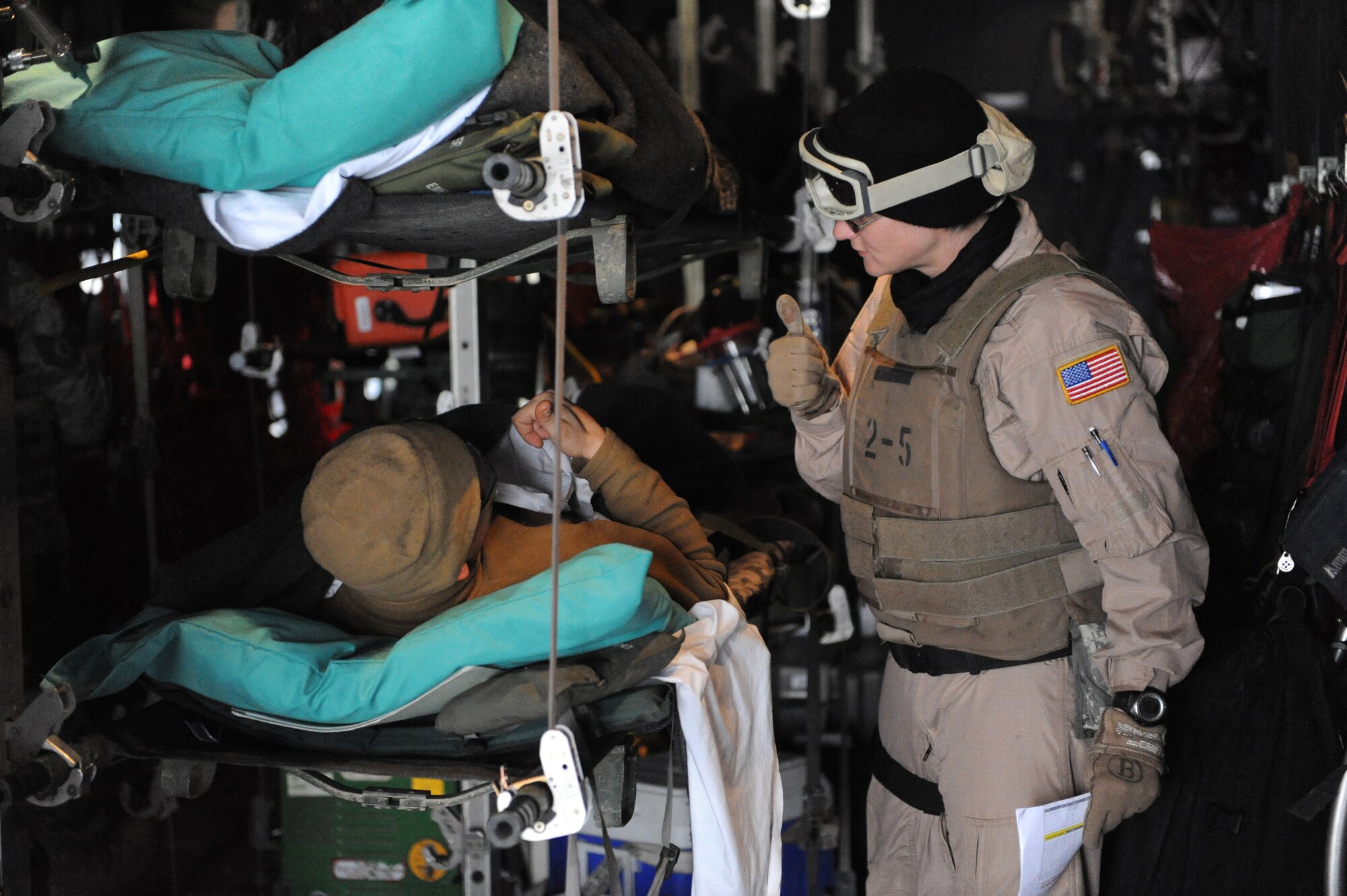 MOSUL, Iraq ? Staff Sgt. Edna Buckelew, 332nd Expeditionary Operations Support Squadron Expeditionary Aeromedical Evacuation Flight medical technician, gives a thumbs-up after checking on a patient Feb. 27. Airmen in the 332nd EAEF transport servicemembers wounded, injured or sick from remote locations to a higher level of medical care. Buckelew is deployed here from Scott Air Force Base, Ill., and is a native of Avon, Ind. (U.S. Air Force photo/Senior Airman Elizabeth Rissmiller)