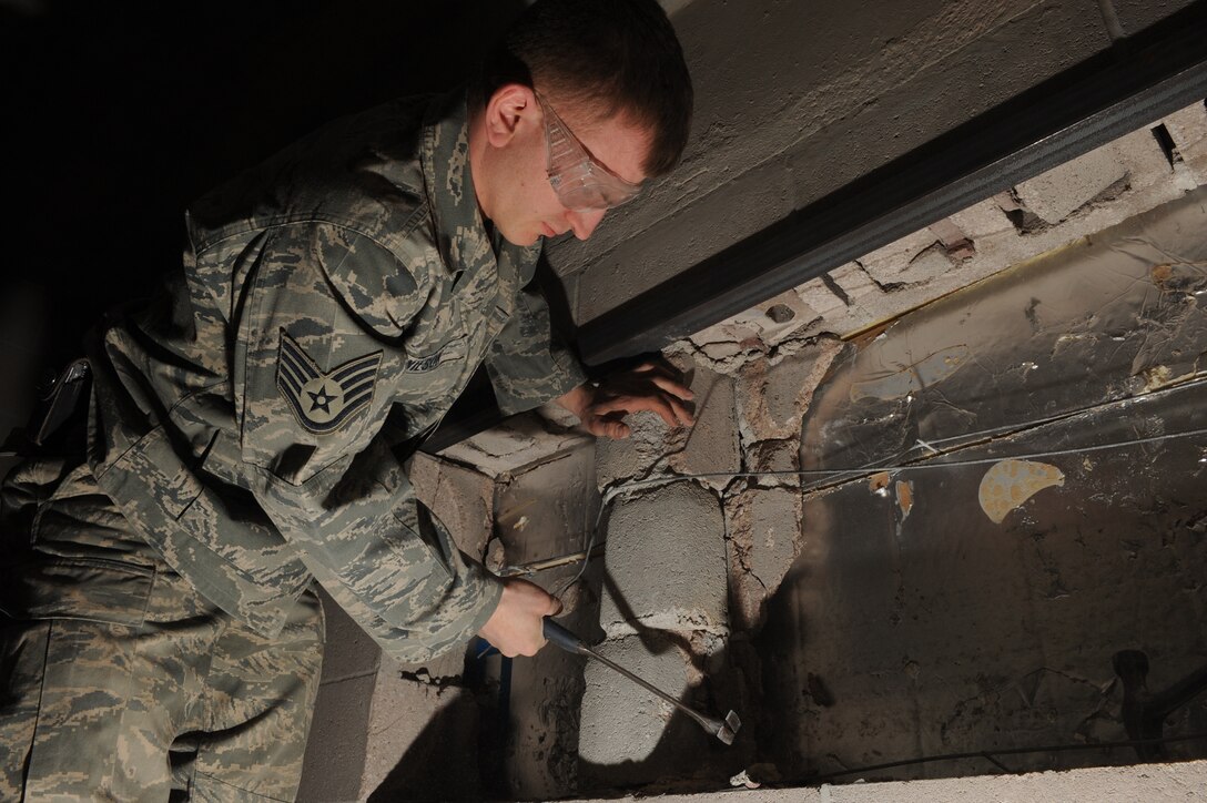 Staff Sgt. Timothy Wilson, 28th Civil Engineer Squadron structural craftsman, uses a hammer to break up a wall for a ventilation system at the future Airmen Ministry Center here, March 5. The center will be a place where Airmen can interact while enjoying entertainment and snacks. (U.S. Air Force photo/Airman 1st Class Joshua J. Seybert) 