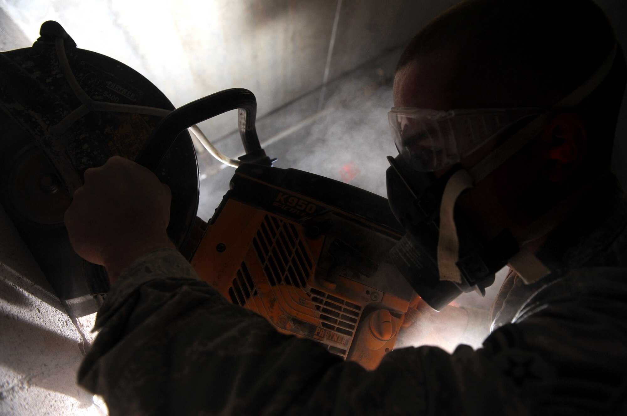 Airman 1st Class Jeremiah Teska, 28th Civil Engineer Squadron structurals apprentice, uses a K950 active handheld concrete saw to cut a hole in a wall for a ventilation system at the future Airmen Ministry Center here, March 3. The center will be a place where Airmen can interact while enjoying entertainment and snacks. (U.S. Air Force photo/Airman 1st Class Joshua J. Seybert) 