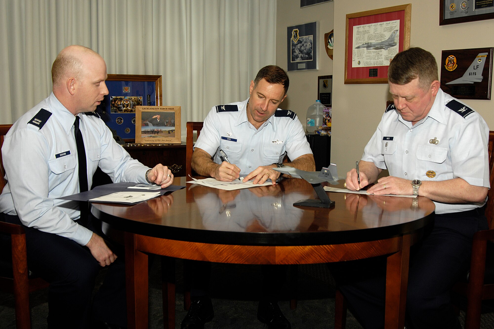 HANSCOM AIR FORCE BASE, Mass. –Col. David Orr (center), 66th Air Base Wing commander and Col. Jeffrey Mayo (right), 66 ABW vice commander complete their Air Force Assistance Fund contribution forms as Capt. Patrick Graham, Hanscom’s AFAF project officer looks on. The Air Force Assistance Fund is going on now through April 10. Hanscom’s goal for this year’s campaign is $37,170.  (U.S. Air Force photo by Linda LaBonte Britt)