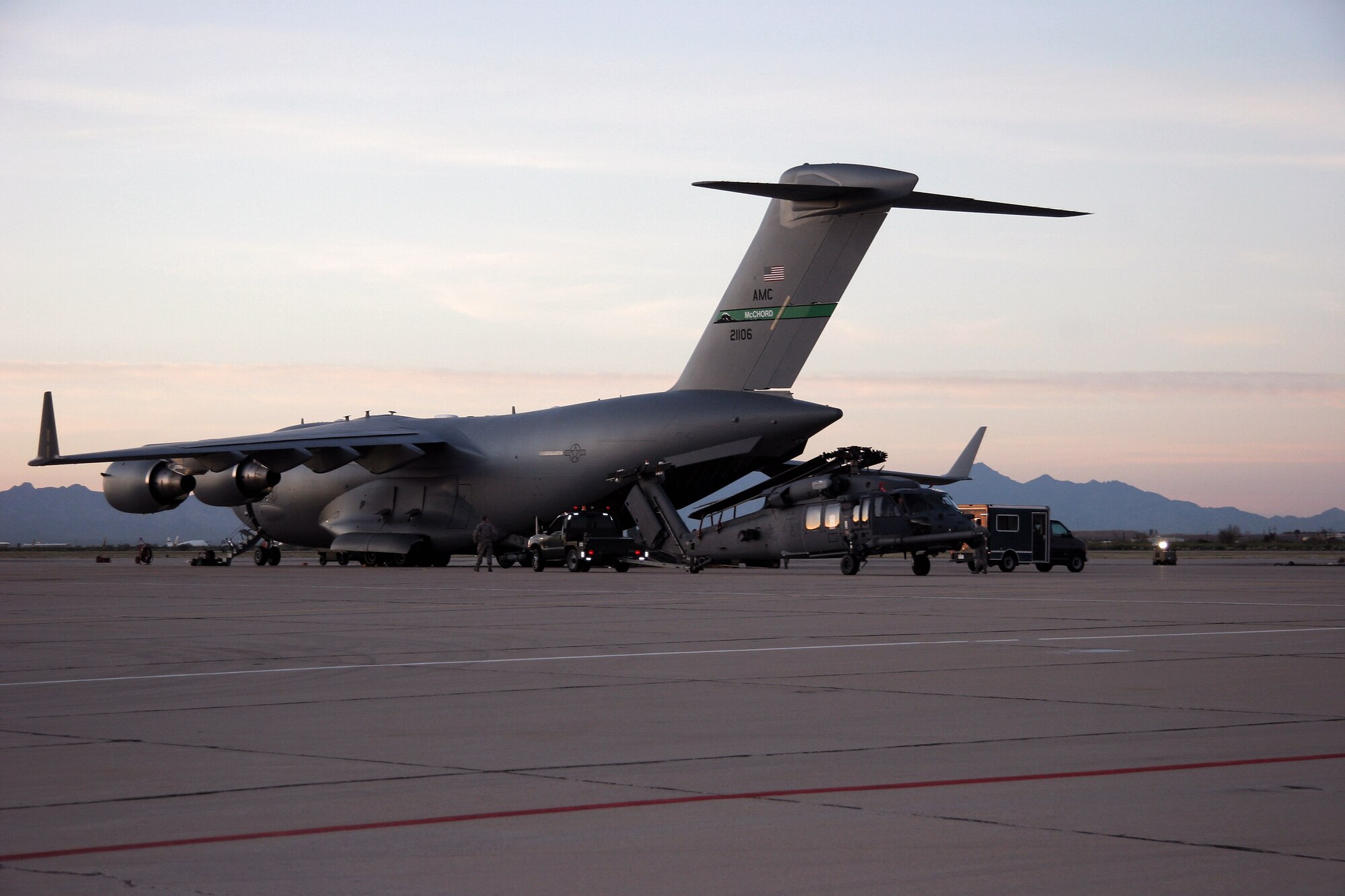 Aircraft maintainters from the 943rd Maintenance Squadron prepare to load a HH-60G Pave Hawk helicopter onto a C-17 Globemaster III March 7 at Davis-Monthan Air Force Base, Ariz. Two helicopters were loaded onto the C-17 from McChord Air Force Base, Wash, and deployed to Patrick AFB, Fla., to augment the launch of the Space Shuttle Discovery. Twenty reservists from the 943rd Rescue Group are supporting this mission. (U.S. Air Force photo/Master Sgt. Ruby Zarzyczny) 
