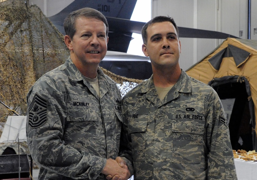 DYESS AIR FORCE BASE, Texas - Airman First Class Jason Fox shakes hands and poses for a photograph with Chief Master Sergeant of the Air Force Rodney McKinley here, Mar 6. Airmen from the 7th Maintenance Group had the opportunity to meet and shake hands with the guest speaker of the Maintenance Professional of the Year awards banquet. (U.S. Air Force photo by Senior Airman Domonique Simmons)