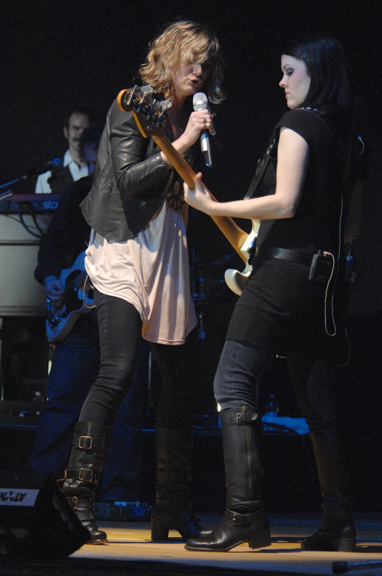 Sugarland vocalist, Jennifer Nettles, and bassist, Annie Clements, dance while performing for the Aviano community March 6 in a hangar on the base flightline. Aviano was the first stop on the band's month-long European tour. (U.S. Air Force photo/Airman 1st Class Tabitha M. Mans)