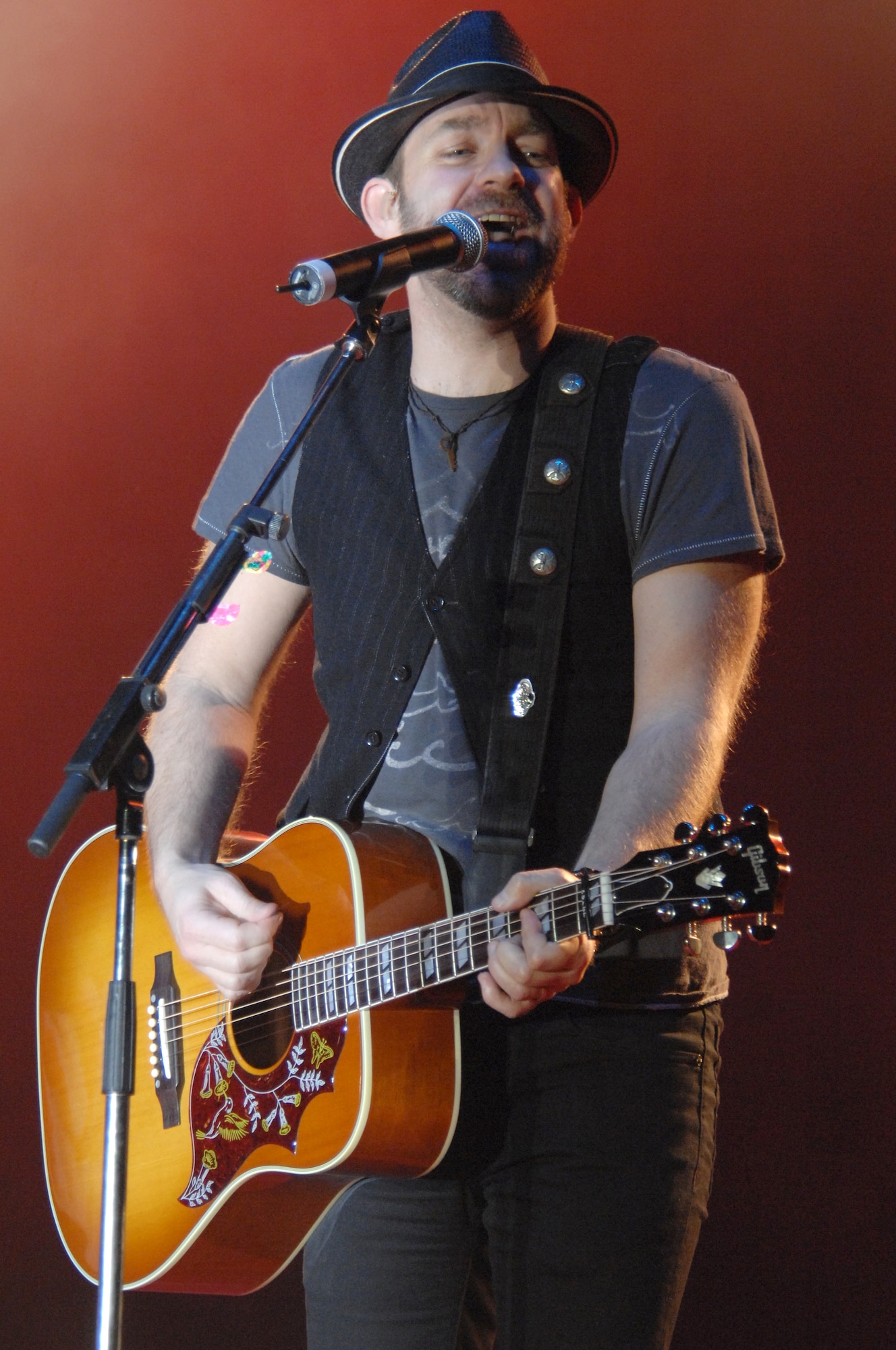 Sugarland guitarist/vocalist, Kristian Bush entertains Aviano Airmen and their families during a concert March 6 on the base flightline. Armed Forces Entertainment hosted the visit to Aviano, which kicked off the band's month-long European tour. (U.S. Air Force photo/Airman 1st Class Tabitha M. Mans)