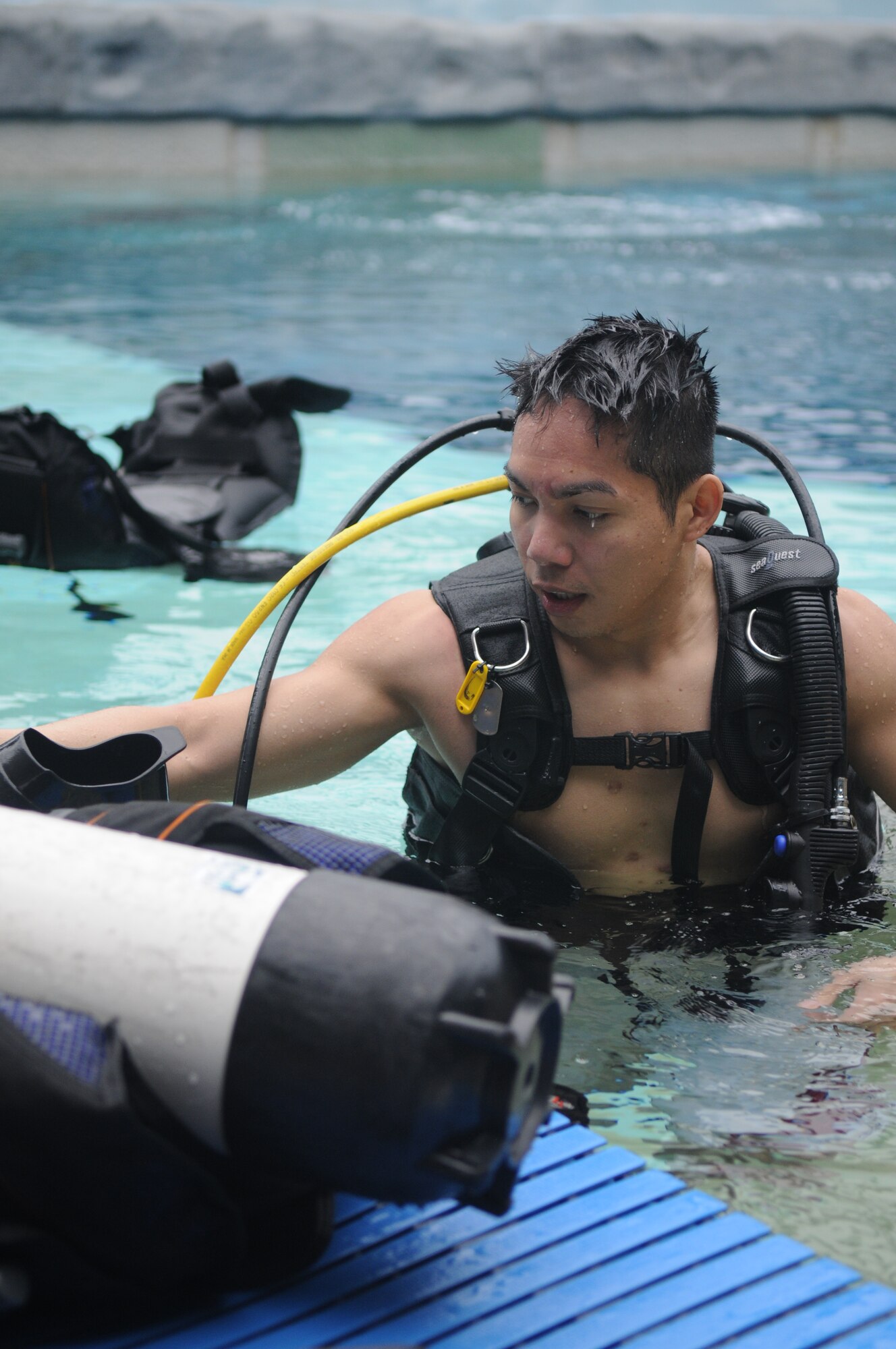 SPANGDAHLEM AIR BASE, Germany -- Tech. Sgt. Michael De Guzman, 52nd Civil Engineer Squadron, collects his scuba gear as part of the Intro to Scuba class offered by Outdoor Recreation March 04, 2009. The class is $74.00 per person, with all gear and instruction provided. (U.S. Air Force photo by Airman 1st Class Staci Miller)