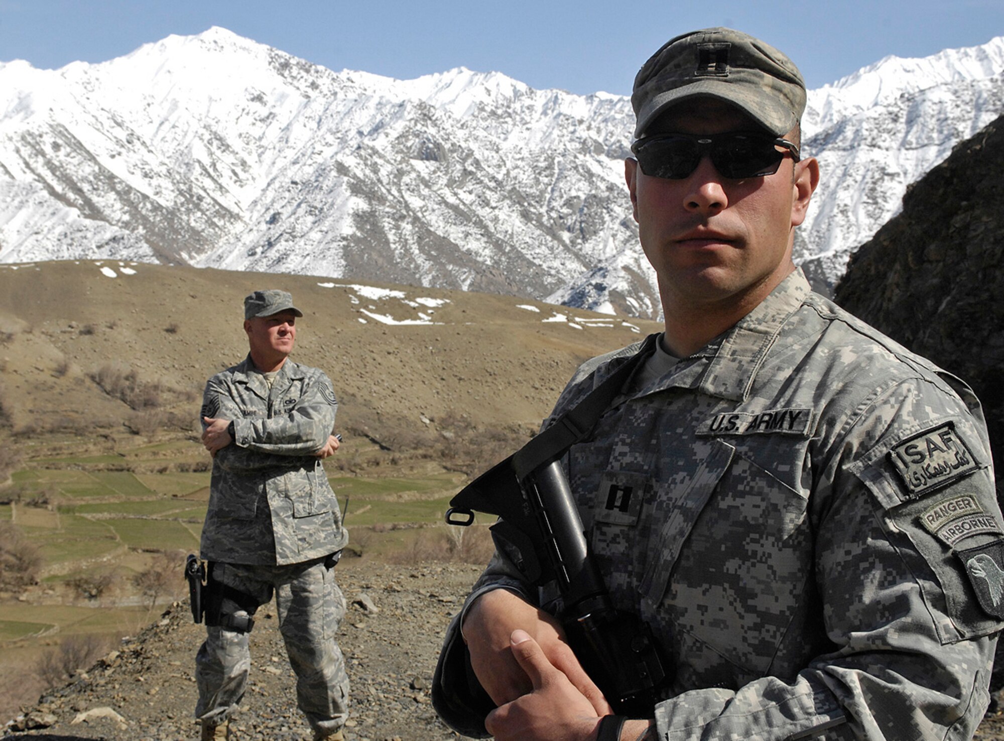 Tech. Sgt. Charles Lambe, Panjshir Provincial Reconstruction Team security forces superintendent, and Army Capt. Chris Mercado, Panjshir PRT operations officer, provide security during a visit by Brig. Gen. Mike Holmes, 455th Air Expeditionary Wing commander, to Panjshir Province, Afghanistan, March 8. Sergeant Lambe is deployed from Luke Air Force Base, Ariz., and Captain Mercado is deployed from Fort Carson, Colo. Soldiers and Airmen assigned to Forward Operating Base Lion are working together to improve the quality of life for villagers in the Rokha district. (U.S. Air Force photo by Staff Sgt. Jason Lake)