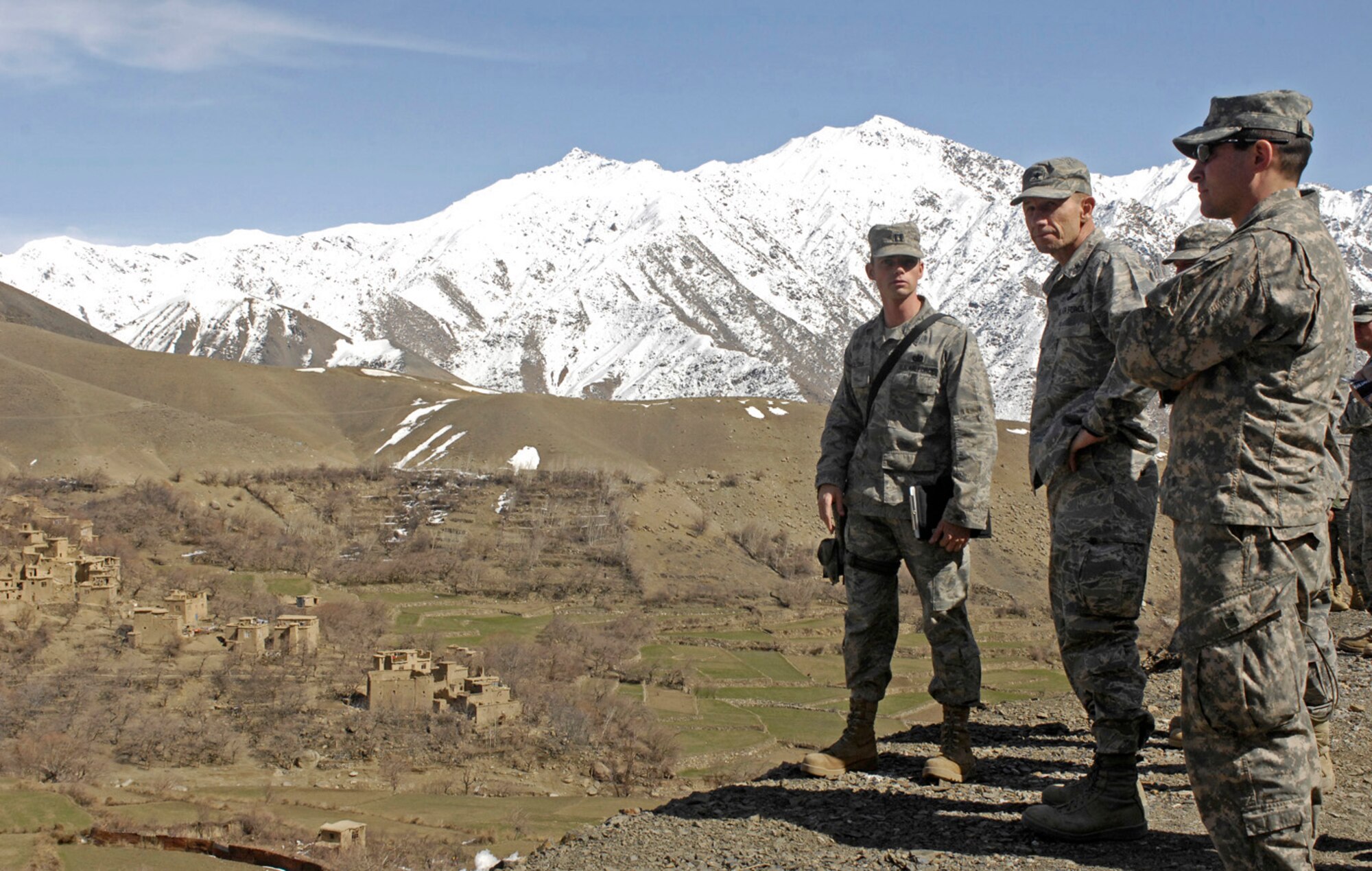 Capt. Patrick Kolesiak, Panjshir Provincial Reconstruction Team chief engineer, shares information about Pyawusht village with Brig. Gen. Mike Holmes, 455th Air Expeditionary Wing commander, during a visit to the Pyawusht basic health clinic March 8. General Holmes, accompanied by Chief Master Sgt. Dennis Vannorsdall, 455th command chief master sergeant, and leadership from the 755th Air Expeditionary Group, came out to Forward Operating Base Lion to talk with Airmen and see what progress has been made in the neighborhoods they are working to improve. The health clinic here in the Rokha district serves approximately 30,000 people. Captain Kolesiak is deployed from the Institute of Technology at Wright-Patterson Air Force Base, Ohio. (U.S. Air Force photo by Staff Sgt. Jason Lake)