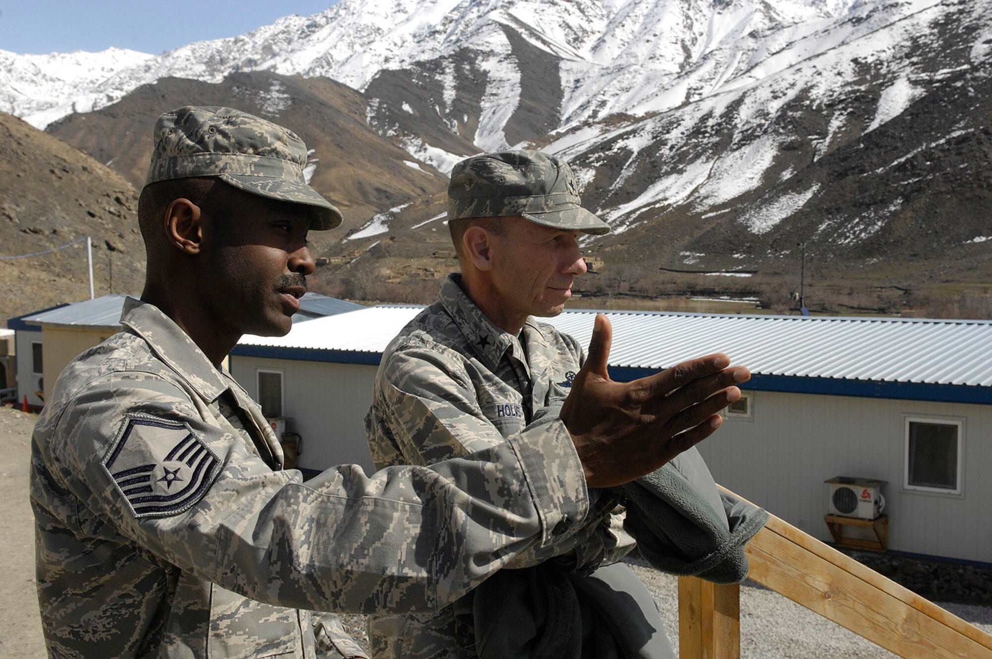 Master Sgt. Kwanza Jenkins, Forward Operating Base Lion mayor, shows Brig. Gen. Mike Holmes, 455th Air Expeditionary Wing commander, around the base located in Panjshir Province, Afghanistan, March 8. General Holmes, accompanied by Chief Master Sgt. Dennis Vannorsdall, 455th command chief master sergeant, and leadership from the 755th Air Expeditionary Group, came out to FOB Lion to talk with Airmen and see what progress has been made in the province Airmen and Soldiers are working to improve. Sergeant Jenkins is deployed here from Little Rock Air Force Base, Ark. (U.S. Air Force photo by Staff Sgt. Jason Lake)