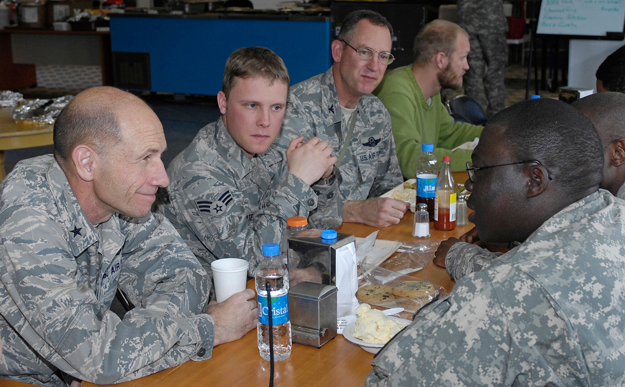 Brig. Gen. Mike Holmes, 455th Air Expeditionary Wing commander, and Col. James Reed, 755th Air Expeditionary Group commander, talk with Senior Airman Lucas Tate and Army Staff Sgt. Fatai Ajao at Forward Operating Base Lion in Panjshir Province March 8. Airman Tate is deployed from Little Rock Air Force Base, Ark., and Sergeant Ajao is deployed from Fort Jackson, S.C. (U.S. Air Force photo by Staff Sgt. Jason Lake)