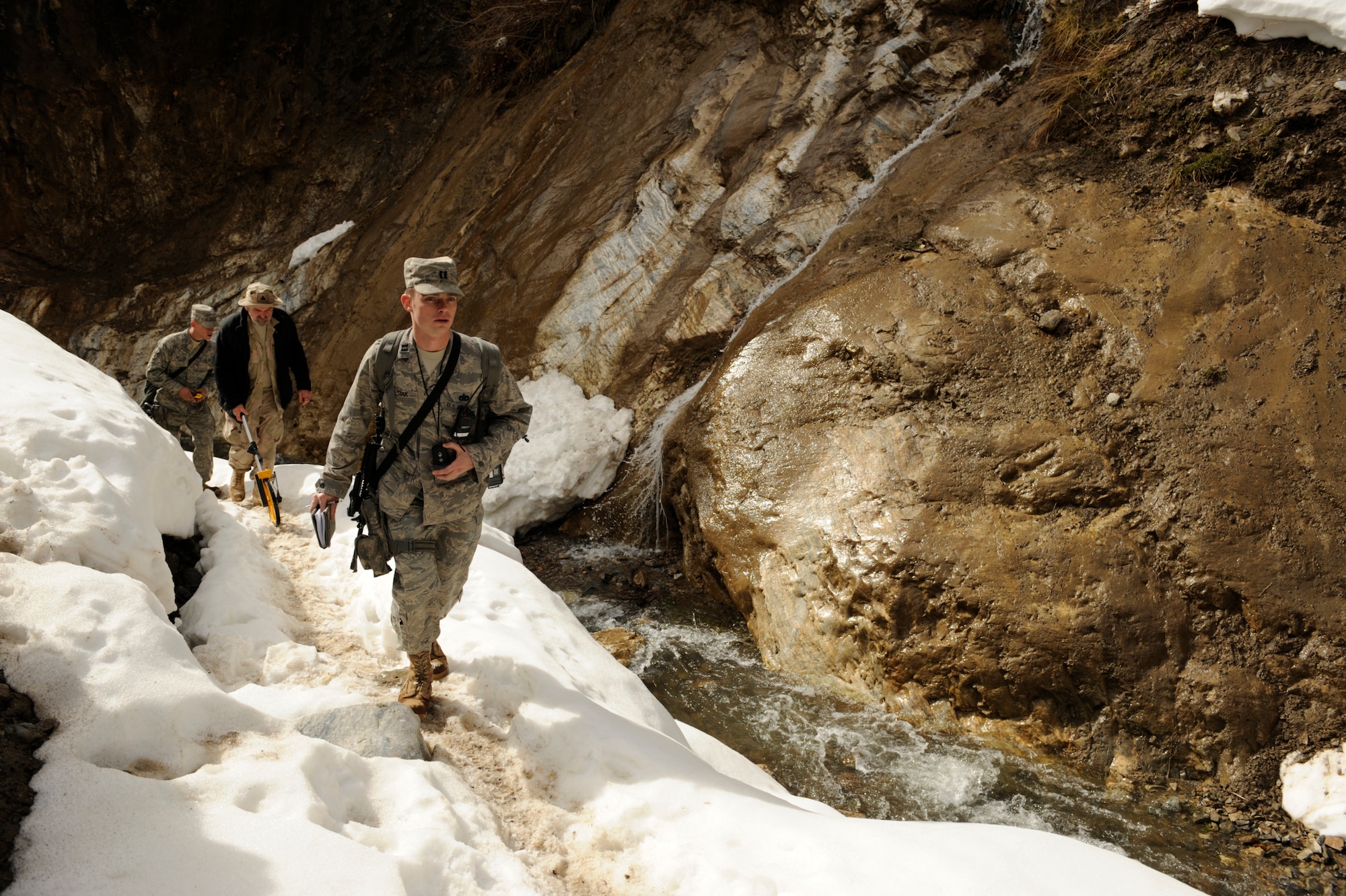 U.S. Air Force Captain Patrick Kolesiak, Panjshir Provincial Reconstruction Team, lead Civil Engineer walks through a valley in Afghanistan Mar. 4, 2009, while surveying for the possibility of constructing a paved road.  (U.S. Air Force photo by Staff Sgt. James L. Harper Jr.)