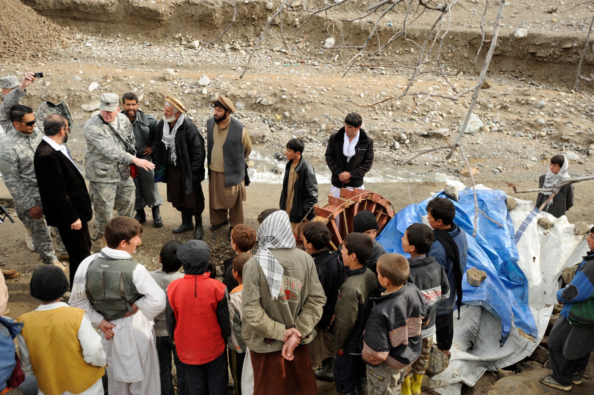 U.S. Air Force Lt. Col. Mark Stratton, Panjshir Provincial Reconstruction Team (PRT) commander, talks to villagers Mar. 4, 2009, about a Micro hydro pump provided by the Panjshir PRT in Afghanistan.  The micro hydro uses water to create power for the village. (U.S. Air Force photo by Staff Sgt. James L. Harper Jr.)Released