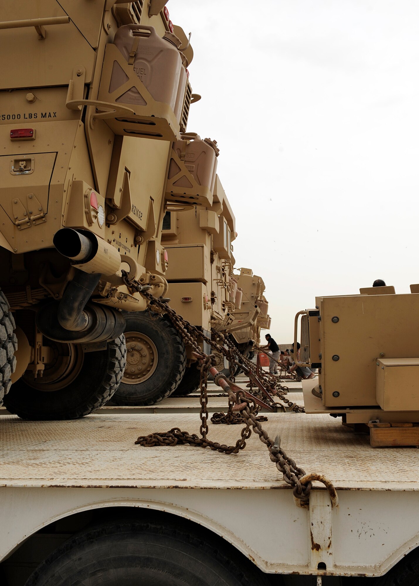 The military vehicles are on the semi trucks, locked down, and ready for their twelve hour trip to Kuwait at Camp Liberty, lraq on Feb. 27, 2009.  The redistribution property assistance team is where the Army resources are distributed for either combat or support operations.  The team consists of Joint Expeditionary Tasking Airmen which fill Army requirements.  One of the redistribution property assistant’s team’s primary duties is to issue military vehicles out to the Army for either combat or support operations.   The personnel at the yard have been able to process more than $1 billion worth of equipment in their six month deployments.  (US Air Force Photo By: Senior Airman Jacqueline Romero)