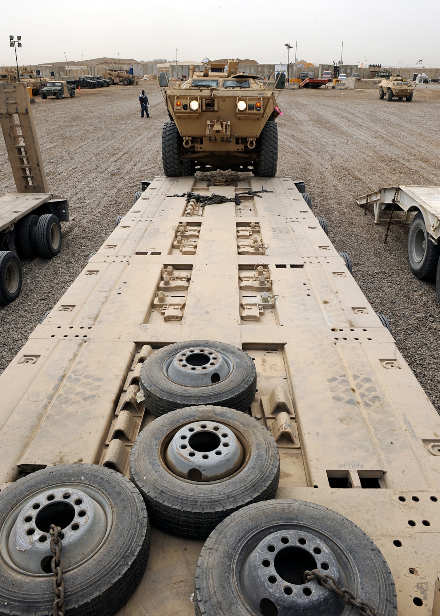 An armored security vehicle drives onto the bed of a semi truck at Camp Liberty, Iraq on Feb. 27, 2009. One of the things the redistribution property assistance team yard does is being able to issue military vehicles out to the Army for either combat or support operations. The personnel at the yard have been able to more than $1 billion worth of equipment in their six month deployments.  (US Air Force Photo By: Senior Airman Jacqueline Romero)