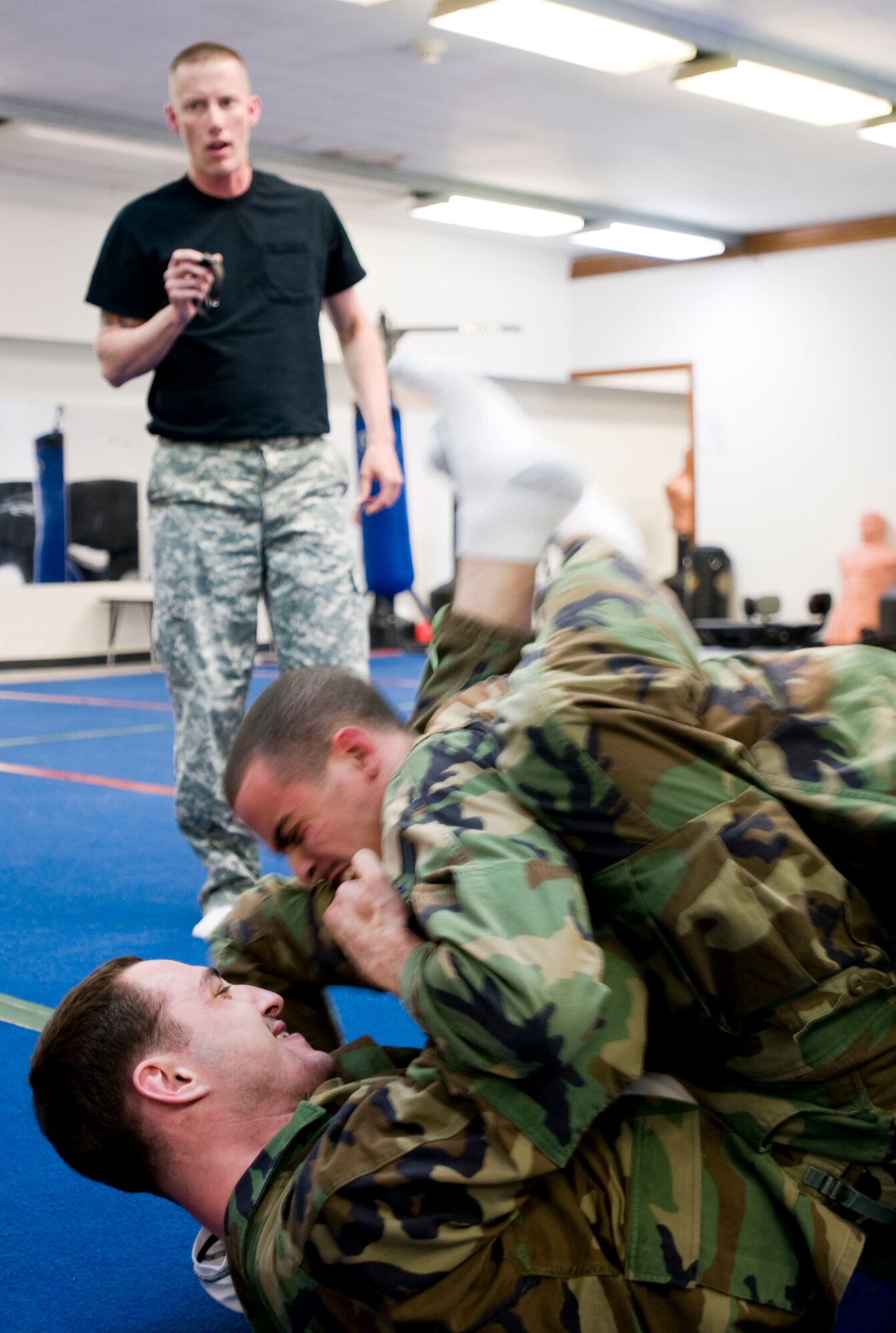 MISAWA AIR BASE, Japan -- Alec Ploof, a contractor for the U.S. Navy, fights off Airman 1st Class George Rendueles, 35th Security Forces Squadron, while an Army combatives instructor times their grappling match Feb. 23, 2009. The Army combatives class is open to U.S. Air Force, U.S. Navy and Japan Air Self Defense Force servicemembers, as well as contractors and civilians on Misawa Air Base. (U.S. Air Force photo by Staff Sgt. Rachel Martinez)