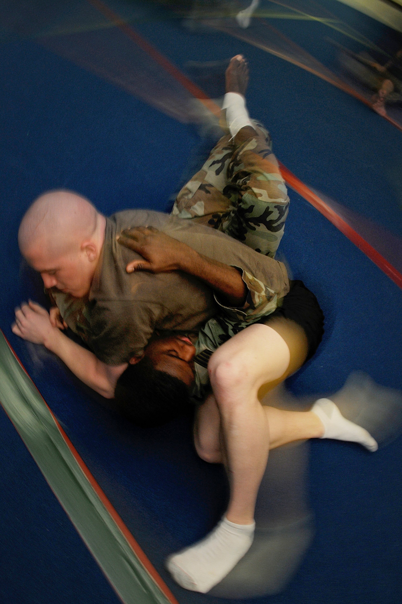 MISAWA AIR BASE, Japan -- Army Sgt. James Harris demonstrates a submission move on Staff Sgt. Darrell Macklin, 35th Medical Operations Support Squadron, during an Army combatives class Feb. 25, 2009. Sergeant Macklin, who takes martial arts lessons off-base, signed up for the five-day combatives course to learn new techniques and build on his skills. (U.S. Air Force photo by Senior Airman Jamal Sutter)