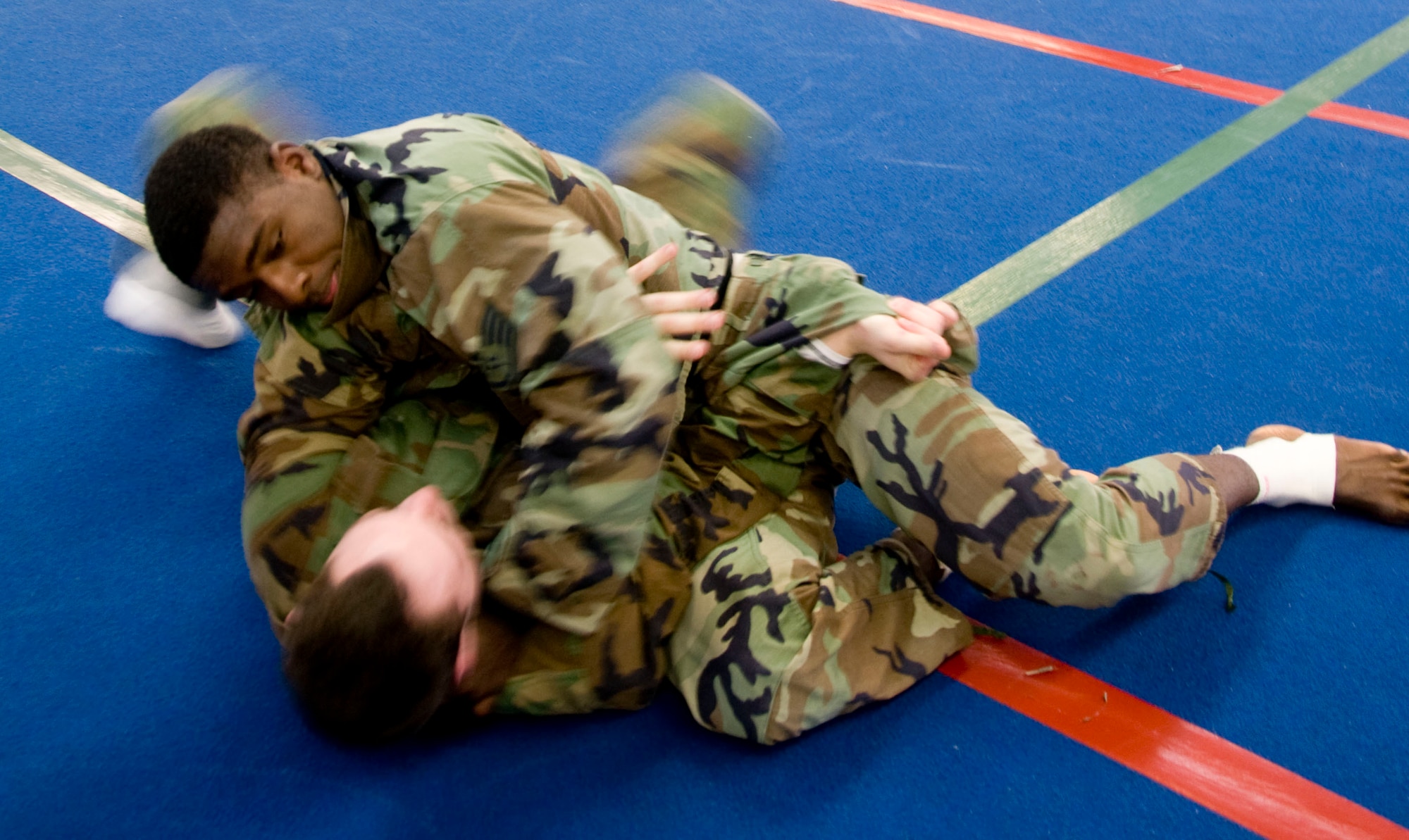 MISAWA AIR BASE, Japan -- Staff Sgt. Darrell Macklin, 35th Medical Operations Support Squadron, works his opponent into a submission during an Army combatives course Feb. 23, 2009. The level-one combatives course teaches basic grappling, dominant body positions and submissions. (U.S. Air Force photo by Staff Sgt. Rachel Martinez)