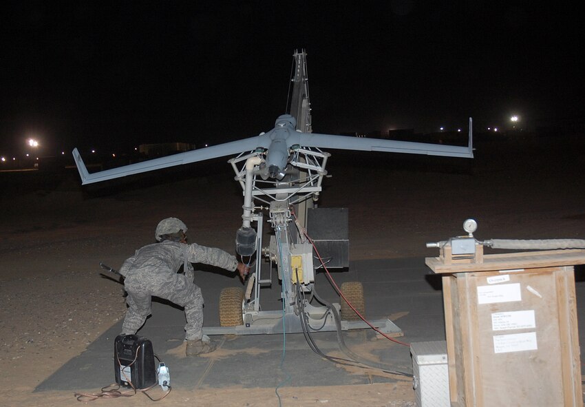CAMP BUCCA, Iraq -- Senior Airman Quantral Fletcher, 887th Expeditionary Security Forces Squadron Scan Eagle maintainer, prepares to launch a Scan Eagle unmanned aerial system from a catapult at Burge Field Feb. 25. The Scan Eagle does not require a runway to take off or land. It is launched into the air by a pneumatic catapult and recovered by a Sky Hook system. Airman Fletcher is originally from Memphis, Tenn. (U.S. Air Force photo by Staff Sgt. Thomas J. Doscher)