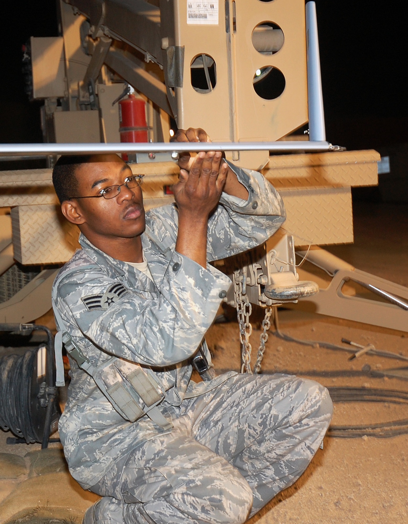 CAMP BUCCA, Iraq -- Senior Airman Quantral Fletcher, 887th Expeditionary Security Forces Squadron Scan Eagle maintainer, performs a pre-flight check on a Scan Eagle's wing before take-off. Scan Eagle maintainers undergo a one-month maintenance course in Washington before being deployed. (U.S. Air Force photo by Staff Sgt. Thomas J. Doscher)