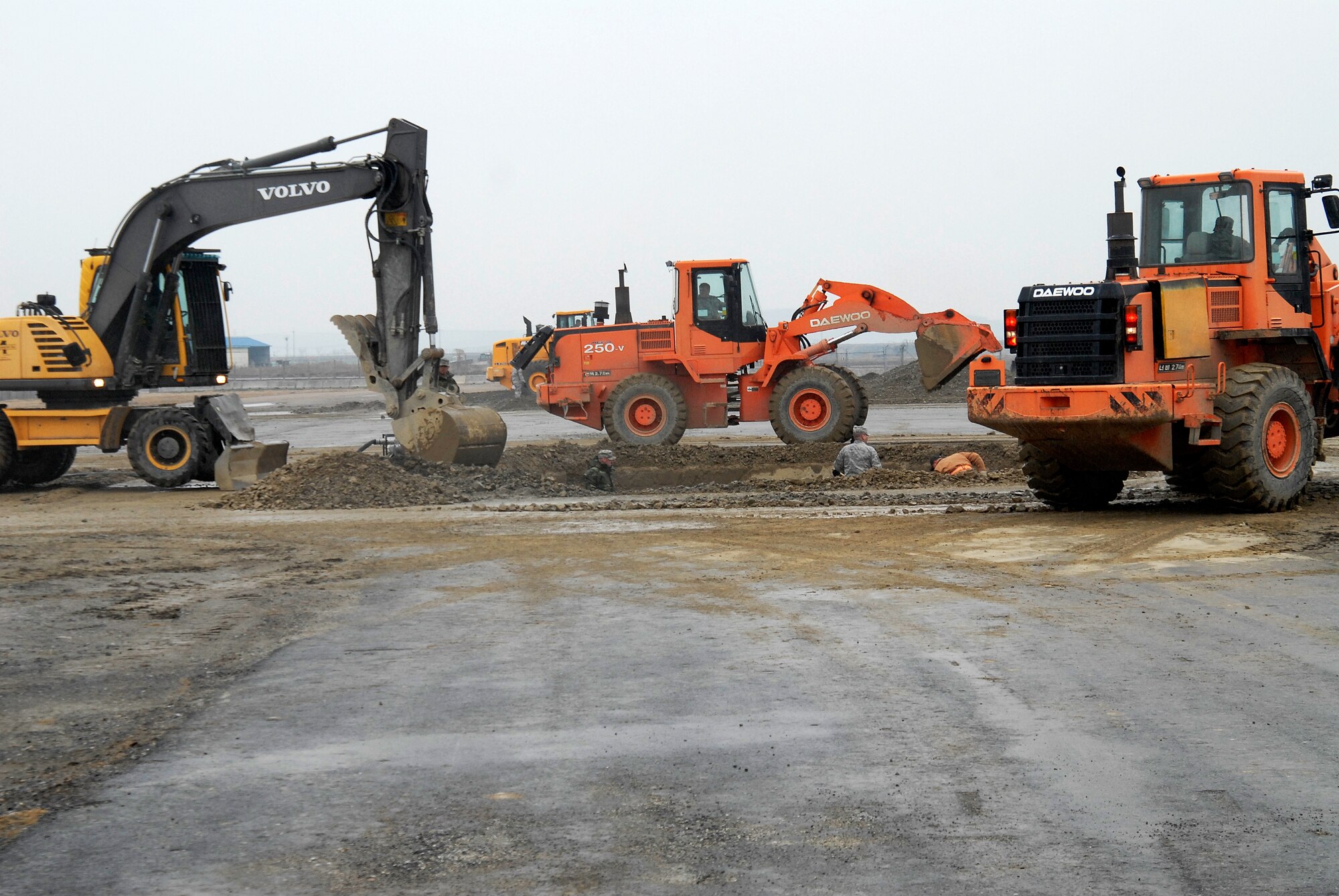 Airmen from the 8th Civil Engineer Squadron begin filling in a crater during an Airfield Damage Repair exercise at Kunsan Air Base, Republic of Korea, March 5, 2009. ADR is a temporary fix on damage caused to the airfield by enemy fire to allow aircraft to quickly get back in the air. (U.S. Air Force Photo by SSgt Jason Colbert)