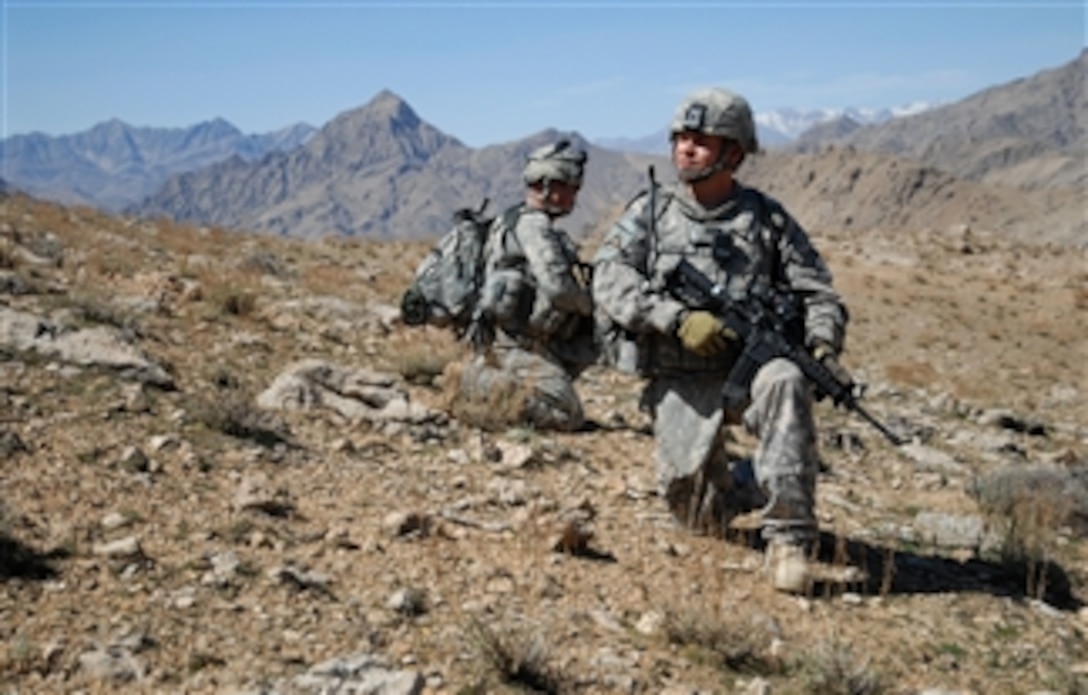 U.S. Army Staff Sgt. Salvador Lopez (right) and Spc. Ashley Shaw, both assigned to 1st Battalion, 4th Infantry Regiment, U.S. Army Europe, take a knee while descending a mountain ridge near Forward Operation Base Lane in Zabul province, Afghanistan, on March 8, 2009.  