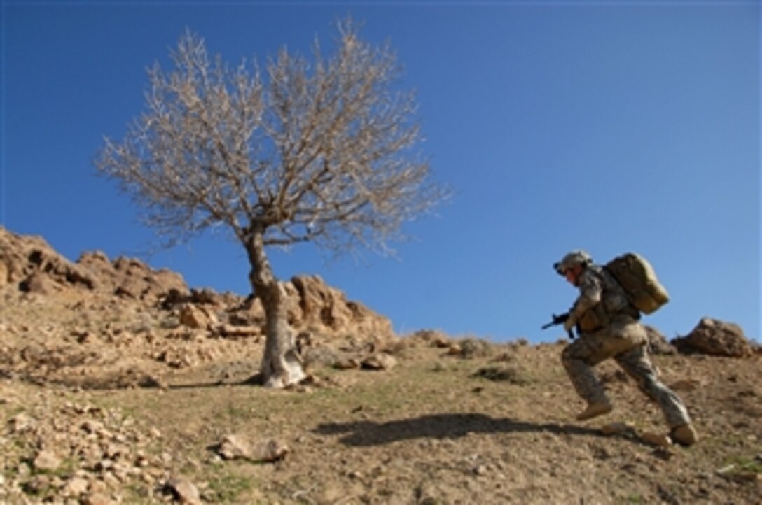 U.S. Army Pfc. Brandon Luff climbs a mountain ridge during a dismounted patrol near Forward Operating Base Lane in the Zabul province of Afghanistan on March 8, 2009.  Luff is assigned to Bravo Company, 1st Battalion, 4th Infantry Regiment.  
