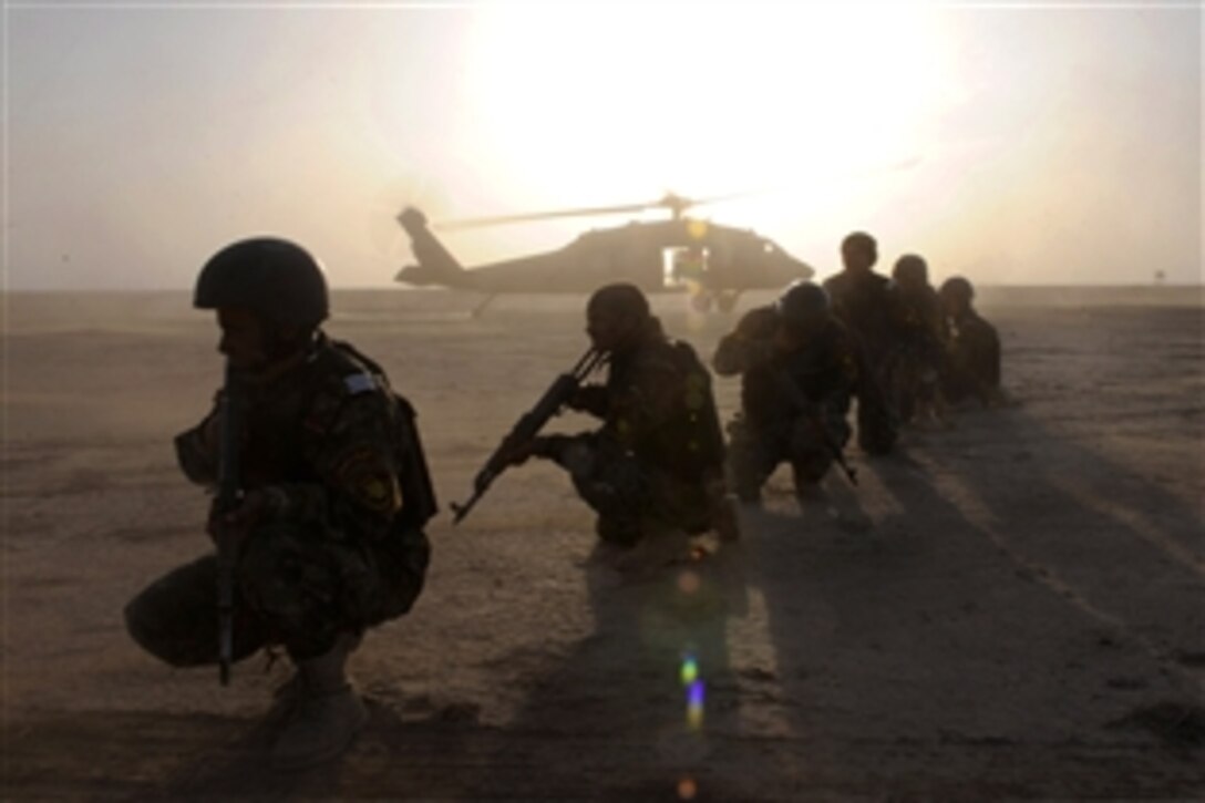 Iraqi policemen from Dhi Qar province pull security during an air-assault training event with U.S. Army soldiers on Camp Cedar, Iraq, March 2, 2009. The U.S. soldiers are assigned to the 1st Cavalry Division’s 2nd Battalion, 12th Cavalry Regiment, 4th Brigade Combat Team.