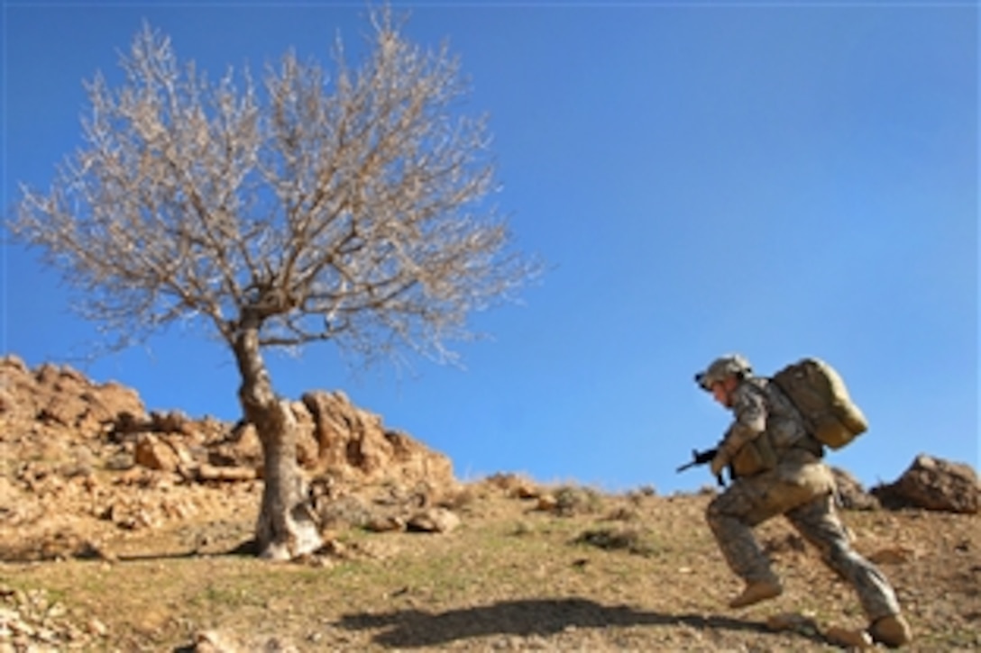 U.S. Army Pfc. Brandon Luff climbs a mountain ridge while on a dismount patrol near Forward Operation Base Lane in Zabul province, Afghanistan, March 8, 2009. Luff is assigned to Company B, 1st Battalion, 4th Infantry Regiment.