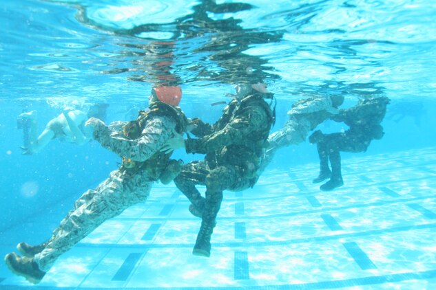 Marines and sailors from throughout the San Diego region perform full-gear rescue assists during the second week of the Marine Combat Instructor Water Survival course aboard Marine Corps Air  Station Miramar March 10. The students would swim several meters and attempt to tow a Marine to another part of the pool.   (U.S. Marine Corps photo by Lance Cpl. Christopher O'Quin) (Released)