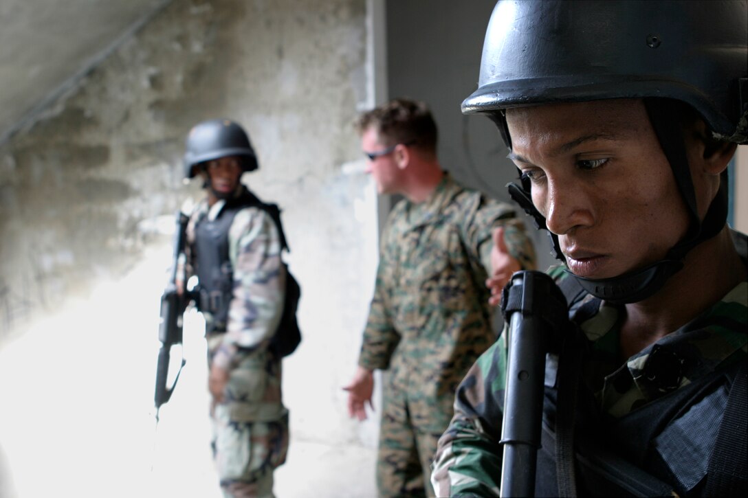 A commando with a Dominican Republic counterterrorism unit known as Secretaria De Las Fuerzas Armadas Commando Especial Contra Terrorismo, posts rear security during close quarter battle training at Ciudad Del Niño here, March 10. A team of Marines with Marine U.S. Marine Corps Forces, Special Operations Command, trained the commandos as part of U.S. Southern Command, Special Operations Command-South’s Exercise FUSED RESPONSE.