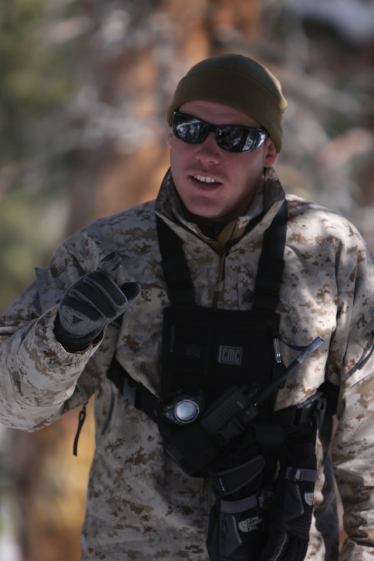 Sgt. Nicholas Strowmatt, an instructor with the Unit Training Group at the Marine Corps Mountain Warfare Training Center Bridgeport, Calif., gives guidance to Marines with 3rd Battalion, 4th Marine Regiment, on building proper snow shelters at training area Penguin March 12.