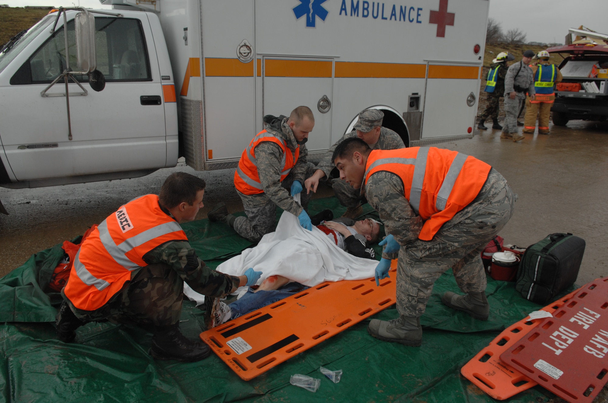 WHITEMAN AIR FORCE BASE, Mo. - Members of Team Whiteman's emergency responders prepare to transport a simulated tornado victim during the Major Accident Response Exercise March 10. The MARE focused on natural disaster preparedness and response for Whiteman and local community emergency responders. (U.S. Air Force photo/Staff Sgt. Charles Larkin)
