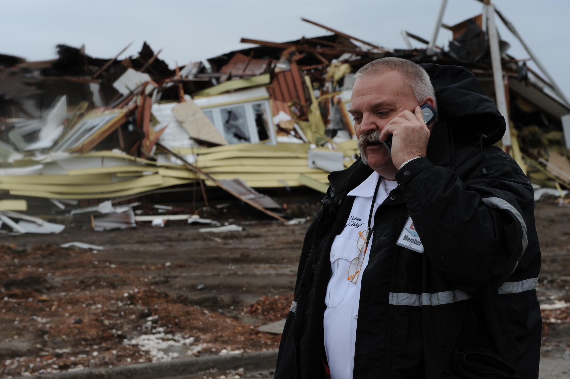 WHITEMAN AIR FORCE BASE, Mo. - David Fisher, 509th Civil Engineer Fire Department assistant training chief, simulates a call to 911 to report a housing unit destroyed during a Major Accident Response Exercise March 10. The MARE focused on focusing on natural disaster preparedness and response for Whiteman and local community emergency responders. (U.S. Air Force photo/Airman 1st Class Carlin Leslie)