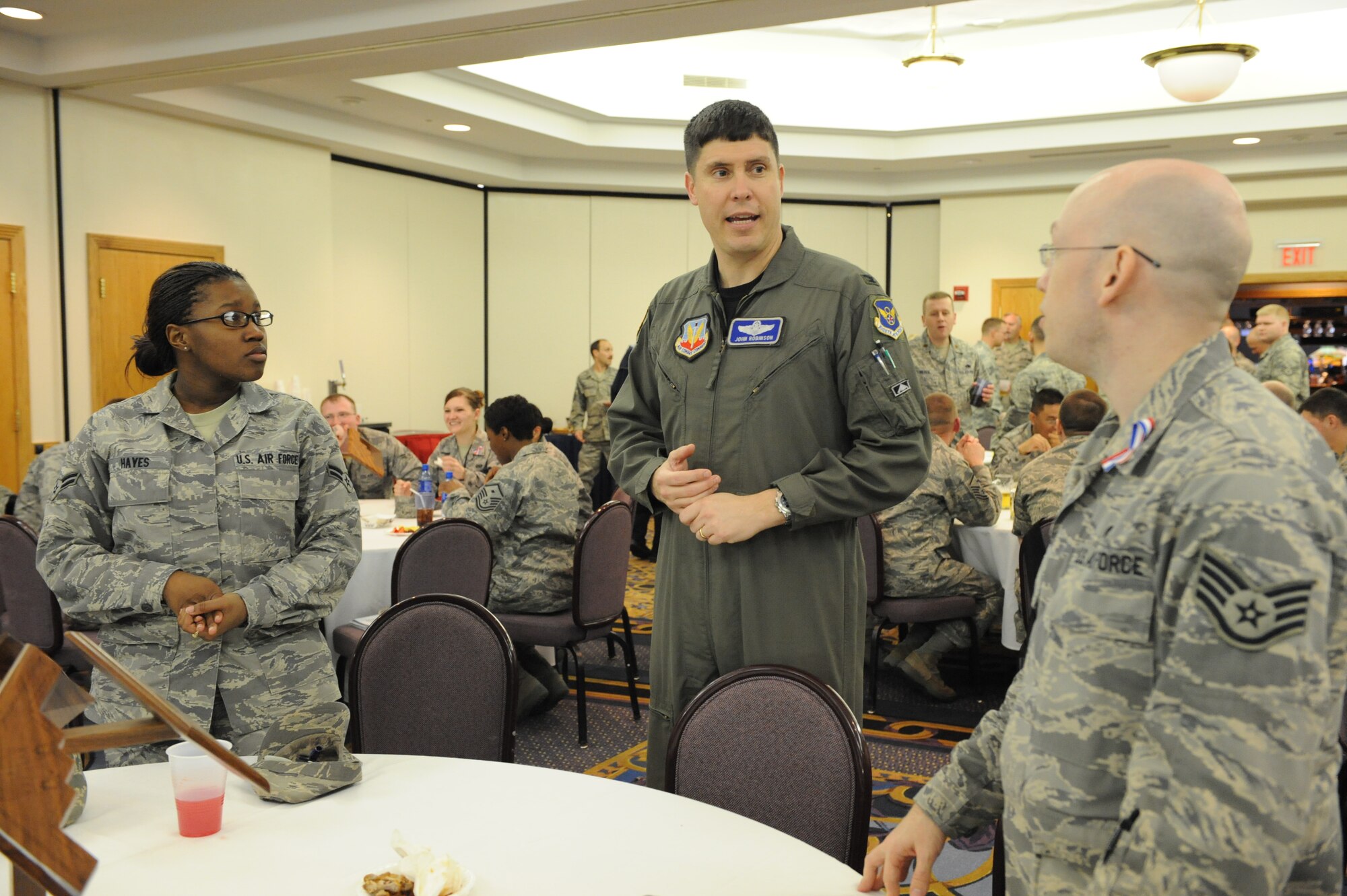Col. John Robinson, 509th Bomb Wing vice commander, speaks to Airman 1st Class Darshayla Hayes (left) and Staff Sgt. John Hogan (right) at the Warrior Welcome Back at the Mission’s End March 11. The Warrior Welcome Back celebrated servicemembers’ return from deployments throughout the last six months with free food, drinks, a slideshow and speeches. (U.S. Air Force photo/Senior Airman Cory Todd)
