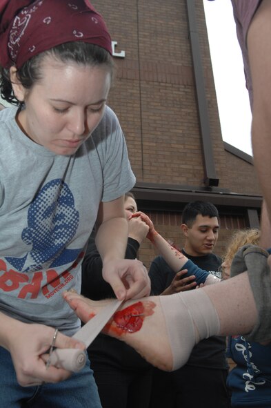 WHITEMAN AIR FORCE BASE, Mo. - Members of Team Whiteman perform first aid and life-saving techniques March 10 during a Major Accident Response Exercise. The MARE simulated a tornado that ran North through base housing, the Base Fitness Center, the Columbia Hall dormitory and the Base Water Treatment Plant. (U.S. Air Force photo/Senior Airman Jessica Snow)