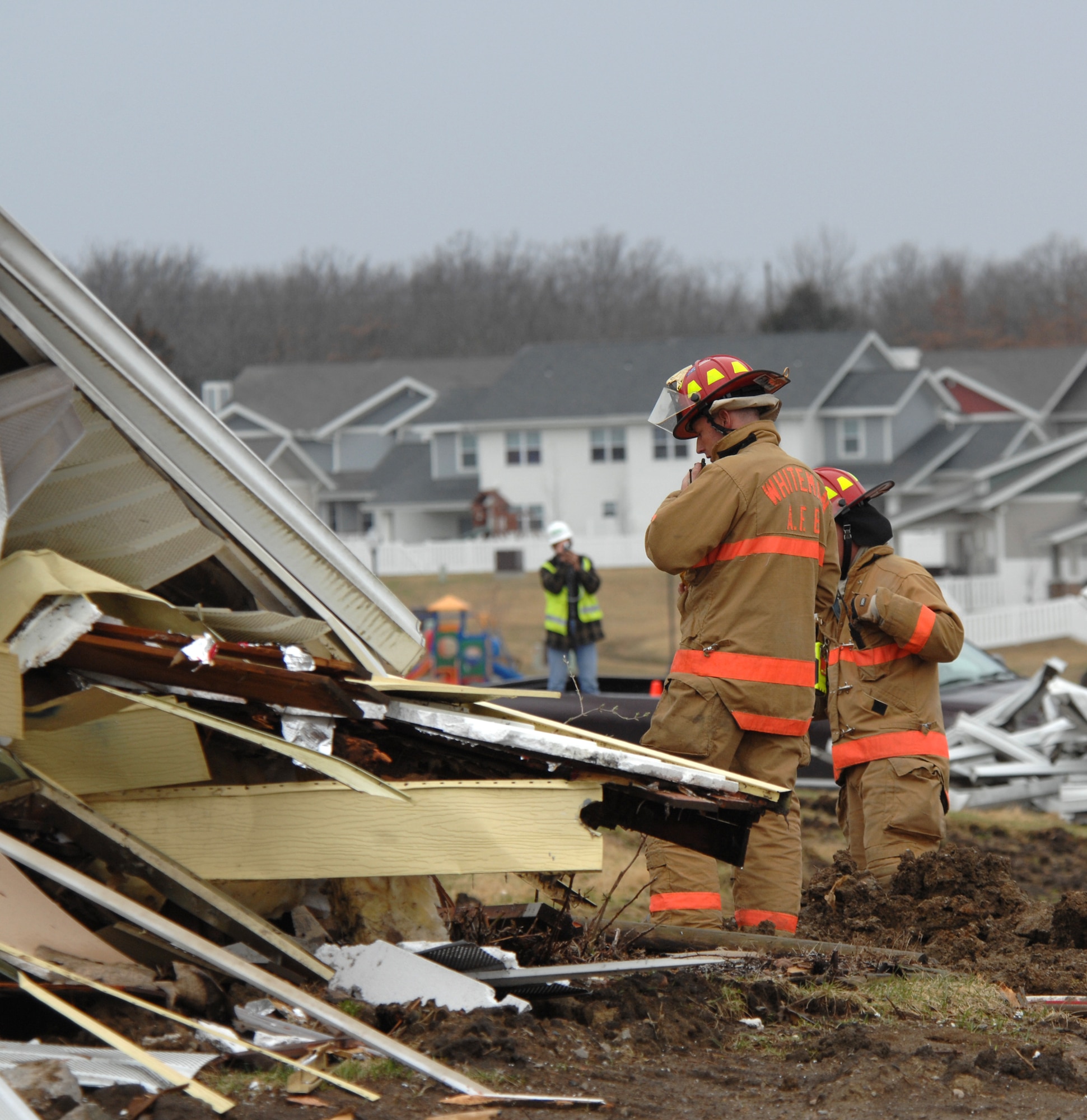 WHITEMAN AFB Mo. –  Members of the Whiteman and Sedalia fire departments perform search-and-rescue operations for victims within the rubble from an imploded house during the Major Accident Response Exercise March 10. The MARE exercise encompassed all base facilities and personnel with the exception of Whiteman Elementary School.  In coordination with the Army Corps of Engineers, the 509th Bomb Wing Plans and Scheduling office used an old base housing unit that was scheduled for demolition to give emergency responders real-world experience of a house that has been hit by a tornado. This exercise was a community joint effort for disaster relief. (U.S. Air Force photo/Staff Sgt. Charles Larkin)