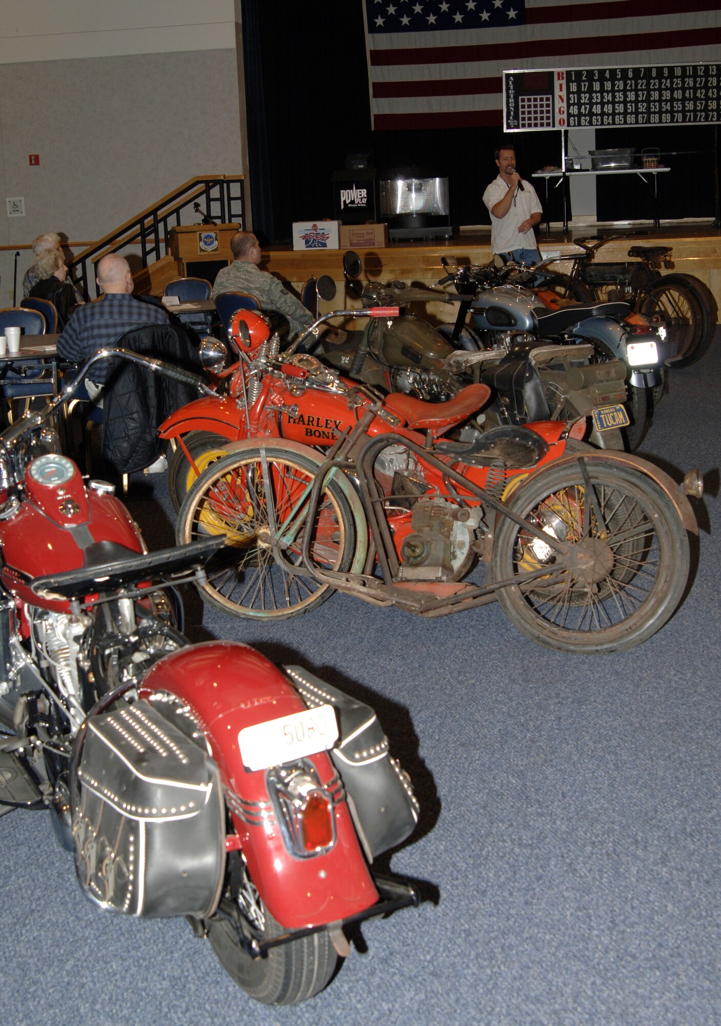 MCCONNELL AIR FORCE BASE, Kan. -- Milt Mounts, Harley Davidson Prairiethunder Chapter marketing director in Wichita, Kan. speaks at a retiree luncheon at the Robert J. Dole Community Center Ballroom, March 10. Mr. Mounts, along with some other members of the Prairiethunder Chapter, brought classic motorcycles to showcase during McConnell’s bike week. (Photo by Senior Airman Laura Suttles)