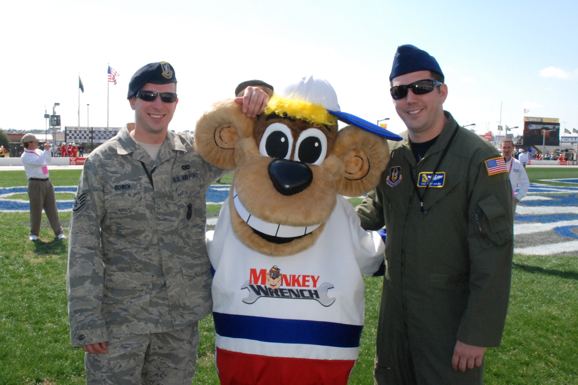 ATLANTA, Ga. - Staff Sgt. Bowen, 94 Security Forces Squadron and Tech. Sgt. Matt Ripley, 700th Airlift Squadron loadmaster, share a "Kodak" moment with Monkey Wrench, the official mascot of the Atlanta Motor Speedway.  Sergeants Bowen and Ripley were guests of the speedway's American Commercial Lines 200 NASCAR Camping World Truck Series race event on Saturday, March 7.  (U.S. Air Force photo/Tech. Sgt. James Branch)