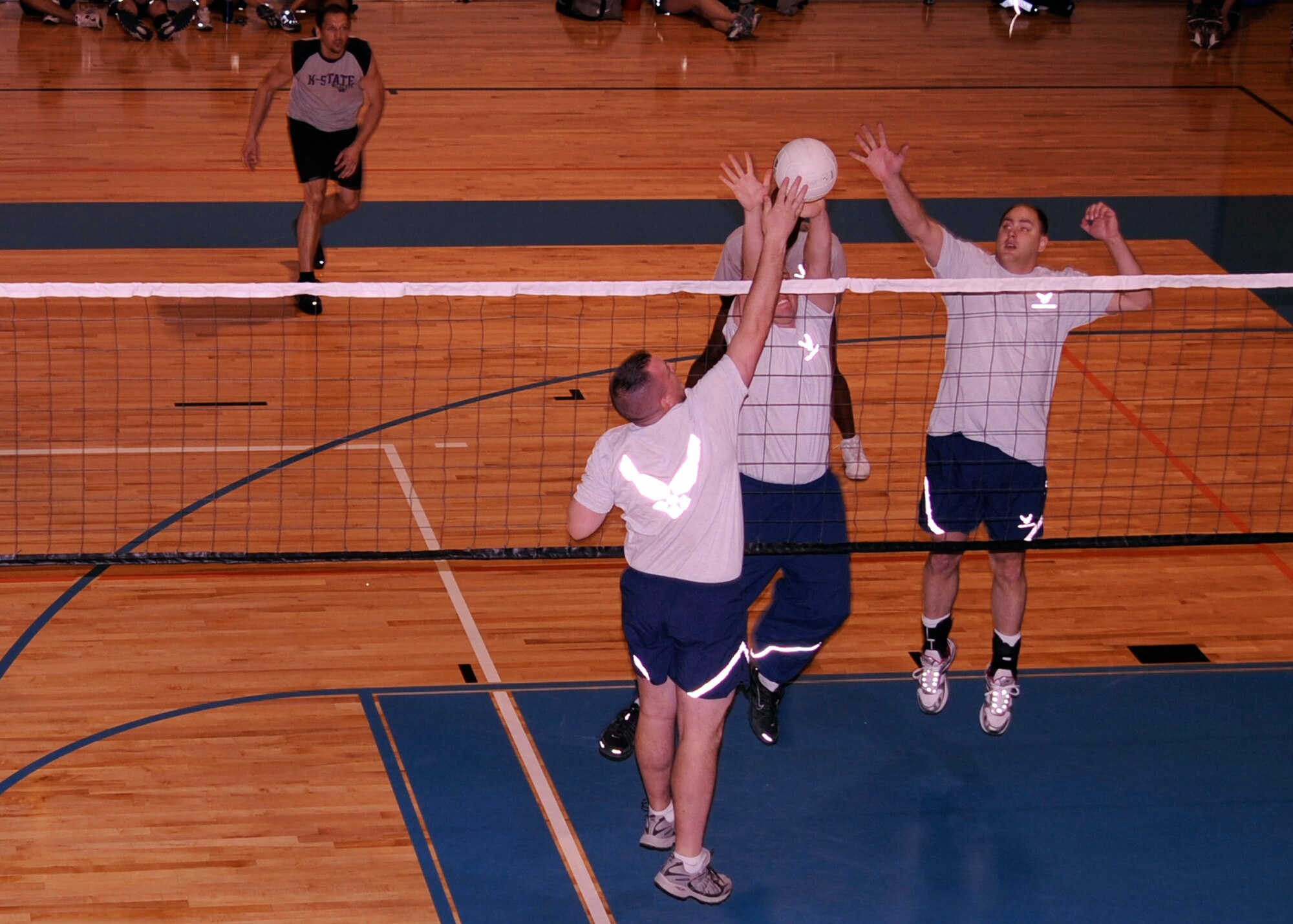 MCCONNELL AIR FORCE BASE, Kan. -- Airmen leap to spike a volleyball in a match during the Air Force Assistance Fund sports day, March 6. (Photo by Airman Justin Shelton)