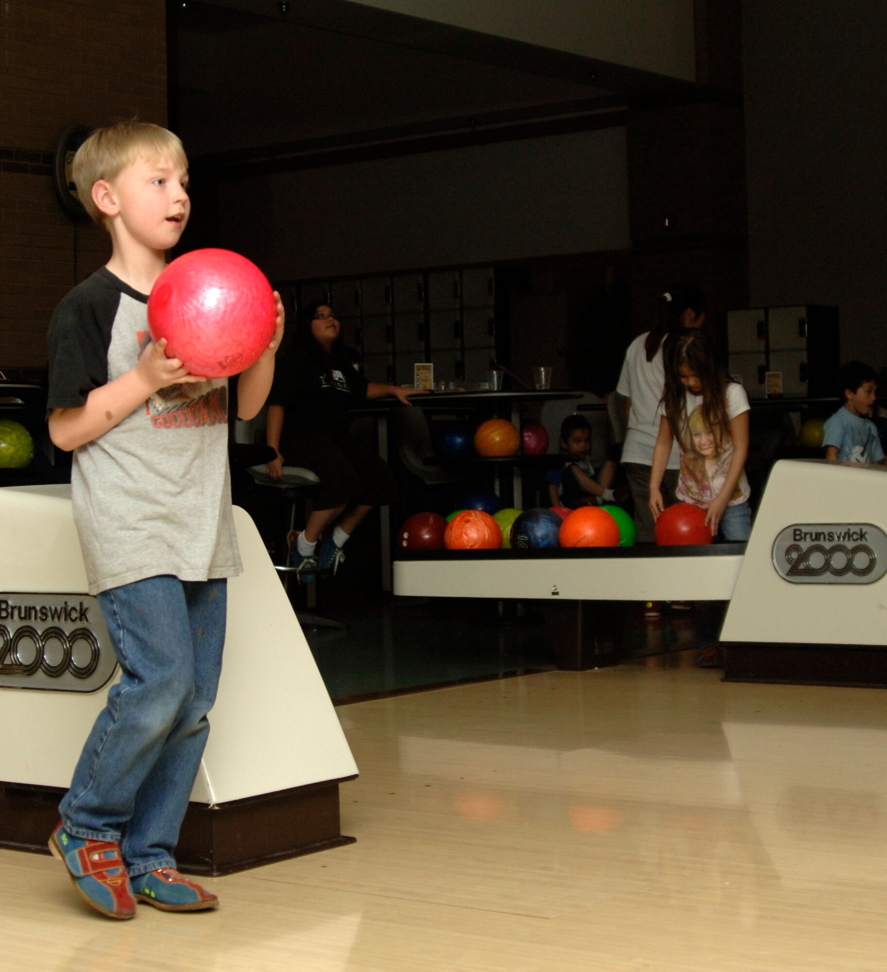 MCCONNELL AIR FORCE BASE, Kan. -- Michael Reaves, 8, son of Tech. Sgt. John Reaves, 22nd Operations Group, bowls at the base bowling alley, March, 9. The bowling alley hosts cosmic bowling every Friday from 7 to 11 pm. (Photo by Senior Airman Laura Suttles)