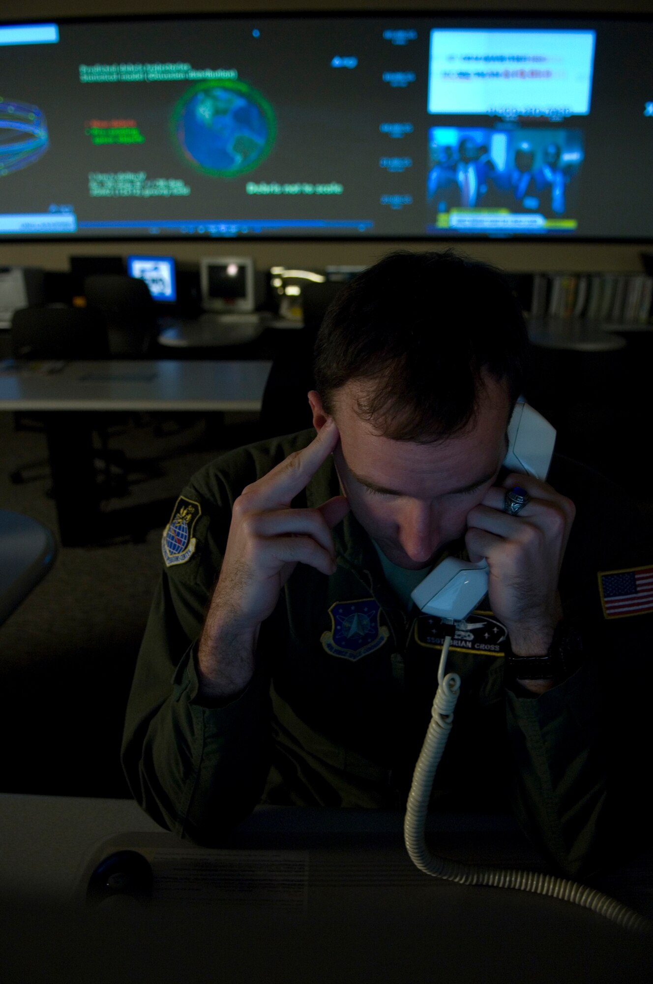 VANDENBERG AIR FORCE BASE, Calif. --  Staff Sgt. Brian Cross, a Missile Warning Sensor Controller from 614th Air and Space Operations Center, receives a phone call with information regarding the Delta II site here Mar. 4.  The purpose of Joint Space Operations Center is to provide a focal point for the operational employment of worldwide joint space forces, and enable the commander of Joint Functional Component Command Space to integrate space power into global military operations. (U.S. Air Force photo/Airman 1st Class Andrew Lee) 
 