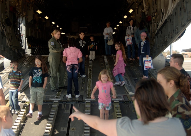 Children and family members get a tour of a C-17 to finish the day at the children's deployment line here March 7. The children's deployment line is a program developed to help show children what their parents go through before they deploy downrange. (U.S. Air Force photo/Senior Airman Timothy Taylor)

