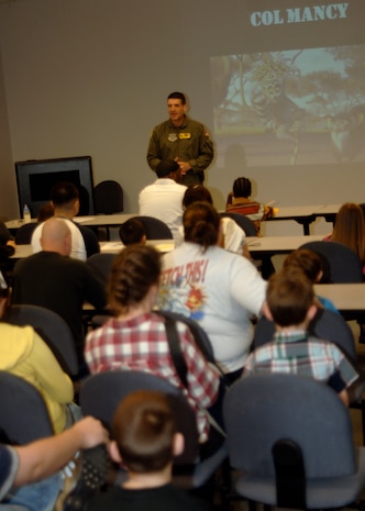 Col. Joseph Mancy briefs family members as he would deploying Airmen before they leave here March 8. The children's deployment line is a program developed to help show children what their parents go through before they deploy downrange. Colonel Mancy is the acting 437 Airlift Wing vice wing commander. (U.S. Air Force photo/Senior Airman Timothy Taylor)

