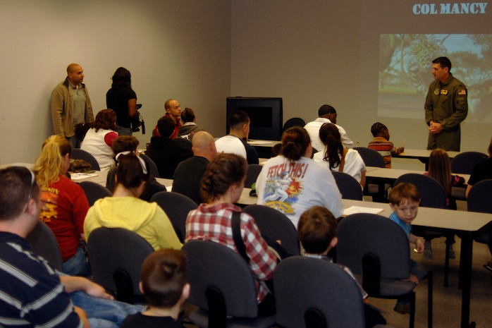 Col. Joseph Mancy briefs family members as he would deploying Airmen before they leave here March 8. The children's deployment line is a program developed to help show children what their parents go through before they deploy downrange. Colonel Mancy is the acting 437 Airlift Wing vice wing commander. (U.S. Air Force photo/Senior Airman Timothy Taylor)

