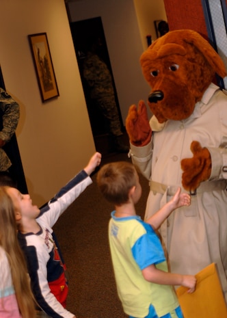 McGruff the Crime dog plays with children at the children's deployment line March 7.The children's deployment line is a program developed to help show children what their parents go through before they deploy downrange. (U.S. Air Force photo/Senior Airman Timothy Taylor)

