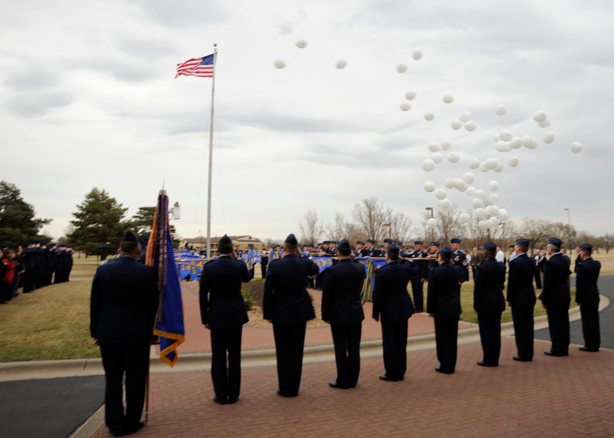 MCCONNELL AIR FORCE BASE, Kan. -- White balloons are released in memory of Col. Michael V. Krueger during a flag folding ceremony, March 9. Civilians and Airmen attended to show their support and remember Colonel Krueger. (Photo by Airman Justin Shelton)