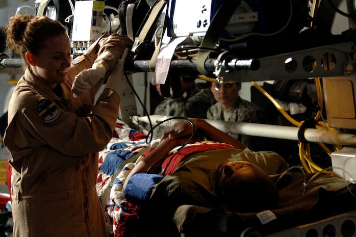 Staff Sgt. Jessica Brandy prepares Tech. Sgt. Omeaterance Mewborn and medical equipment for the next Army Wives scene being filmed inside of a Charleston C-17 here March 10.  Several locations on Charleston AFB were filmed, including the passenger terminal and the base shoppette. Sergeant Brandy is with the 315th Aeromedical Evacuation Squadron and Sergeant Mewborn is with the 437th Maintenance Operations Squadron. (U.S. Air Force photo/Senior Airman Timothy Taylor)